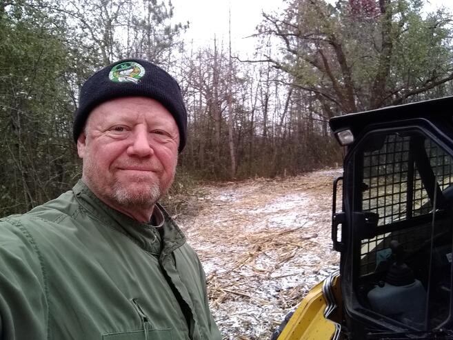 guy posing in front of clearing