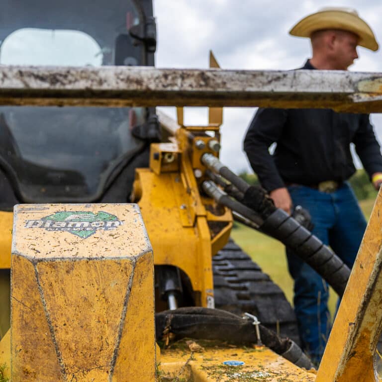 guy by skid steer disc mulcher