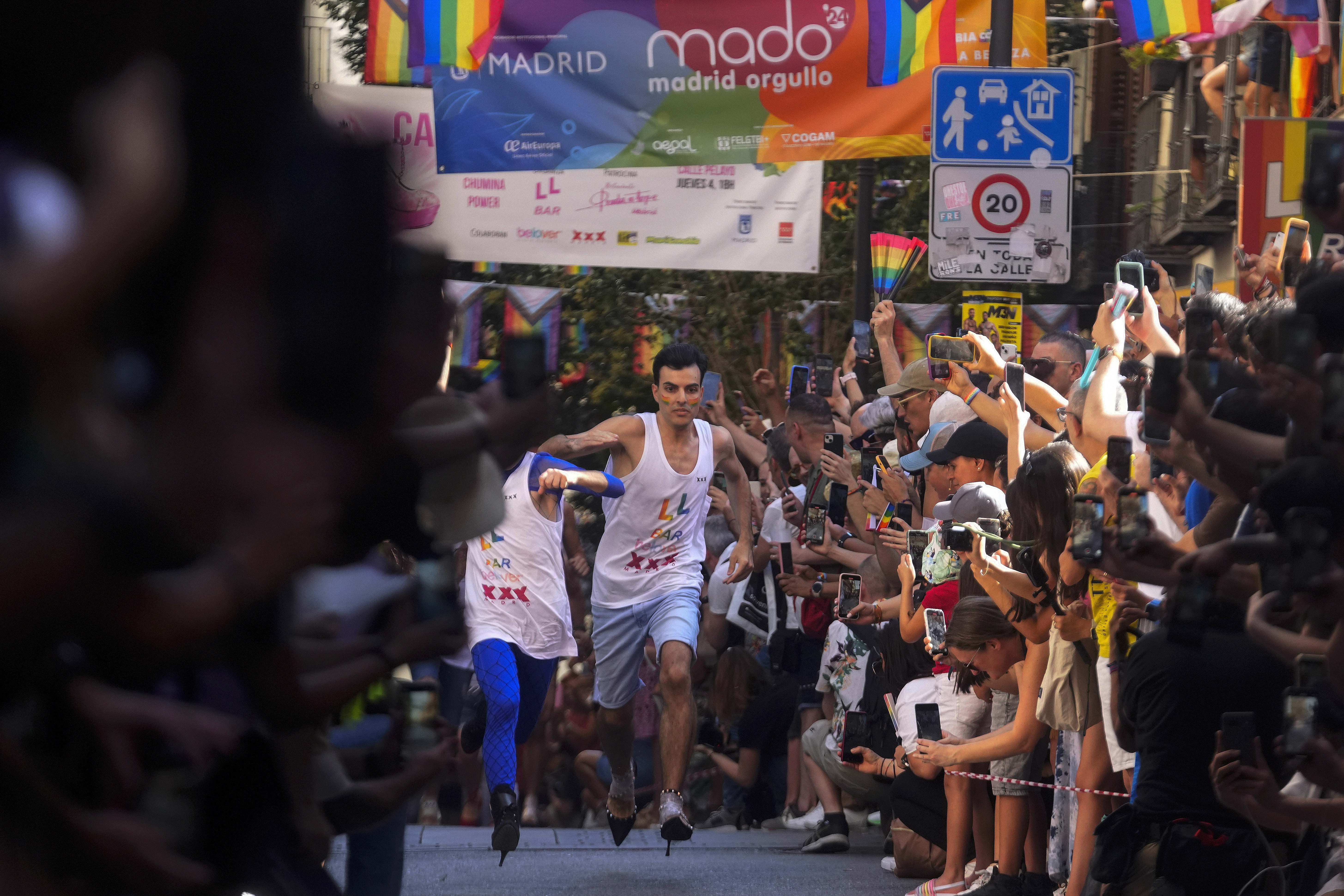 Participants compete during the Pride Week annual high heels race in the Chueca district, a popular area for the gay community in Madrid, Spain, Thursday, July 4, 2024. (AP Photo/Paul White)