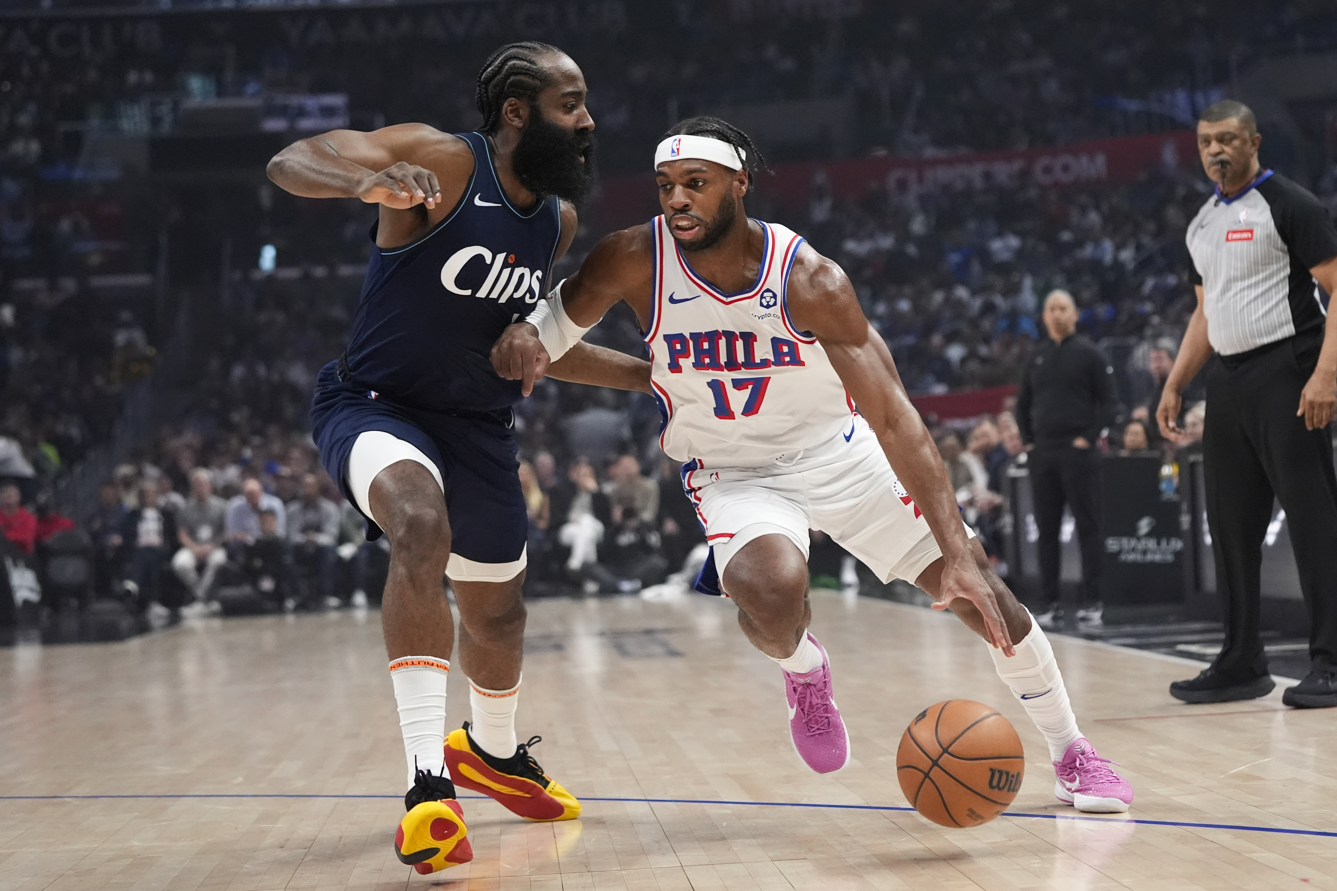 FILE - Philadelphia 76ers guard Buddy Hield (17) drives past Los Angeles Clippers guard James Harden during the first half of an NBA basketball game March 24, 2024, in Los Angeles. The 76ers continued a busy offseason by orchestrating a sign-and-trade deal that sends Hield to the Golden State Warriors for a 2031 second-round draft pick it received from the Dallas Mavericks, according to a person with knowledge of the deal. (AP Photo/Jae C. Hong, File)