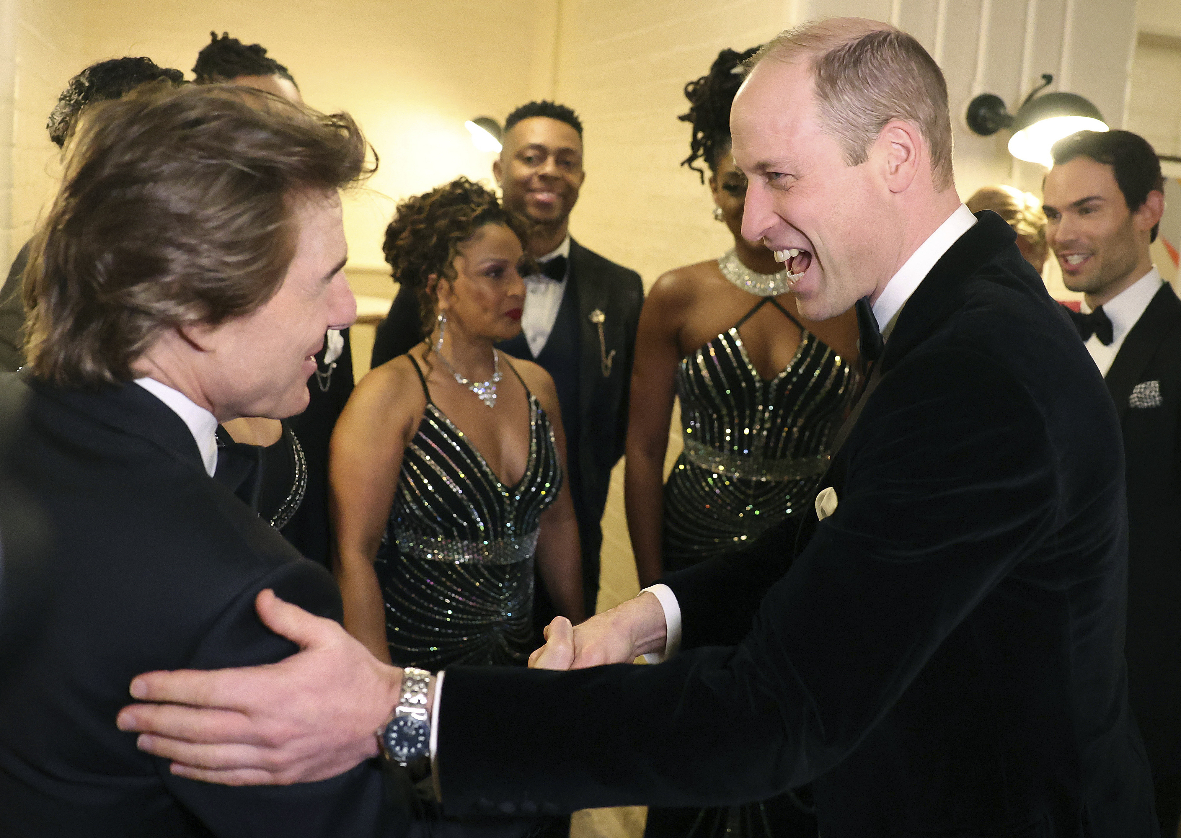 Britain's Prince William, the Prince of Wales, right, reacts as he speaks with US actor Tom Cruise, at the London Air Ambulance Charity Gala Dinner at The OWO in central London, Wednesday, Feb. 7, 2024. (Daniel Leal/Pool Photo via AP)