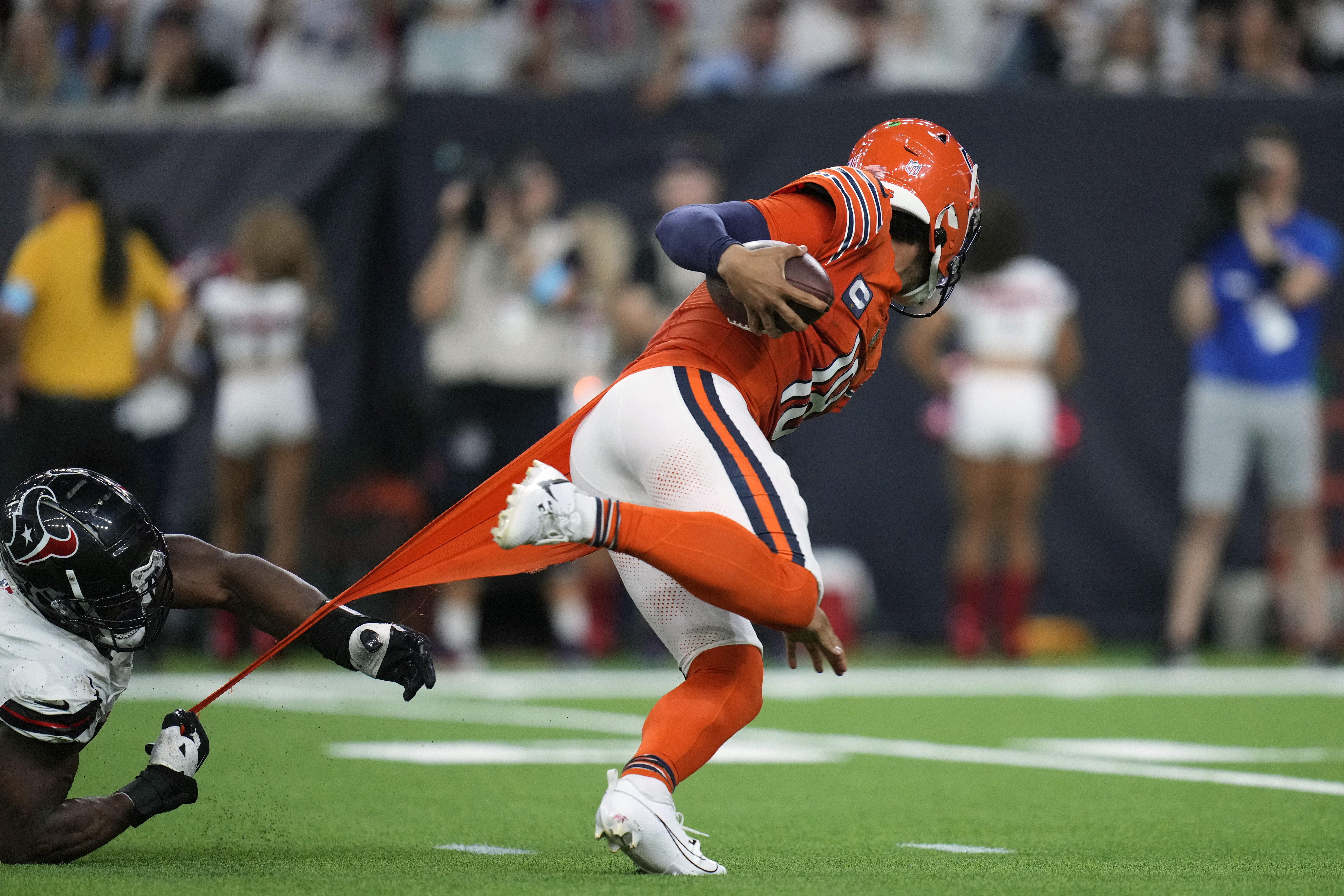 Chicago Bears quarterback Caleb Williams, right, scrambles away from Houston Texans defensive end Danielle Hunter during the second half of an NFL football game Sunday, Sept. 15, 2024, in Houston. (AP Photo/Eric Gay)