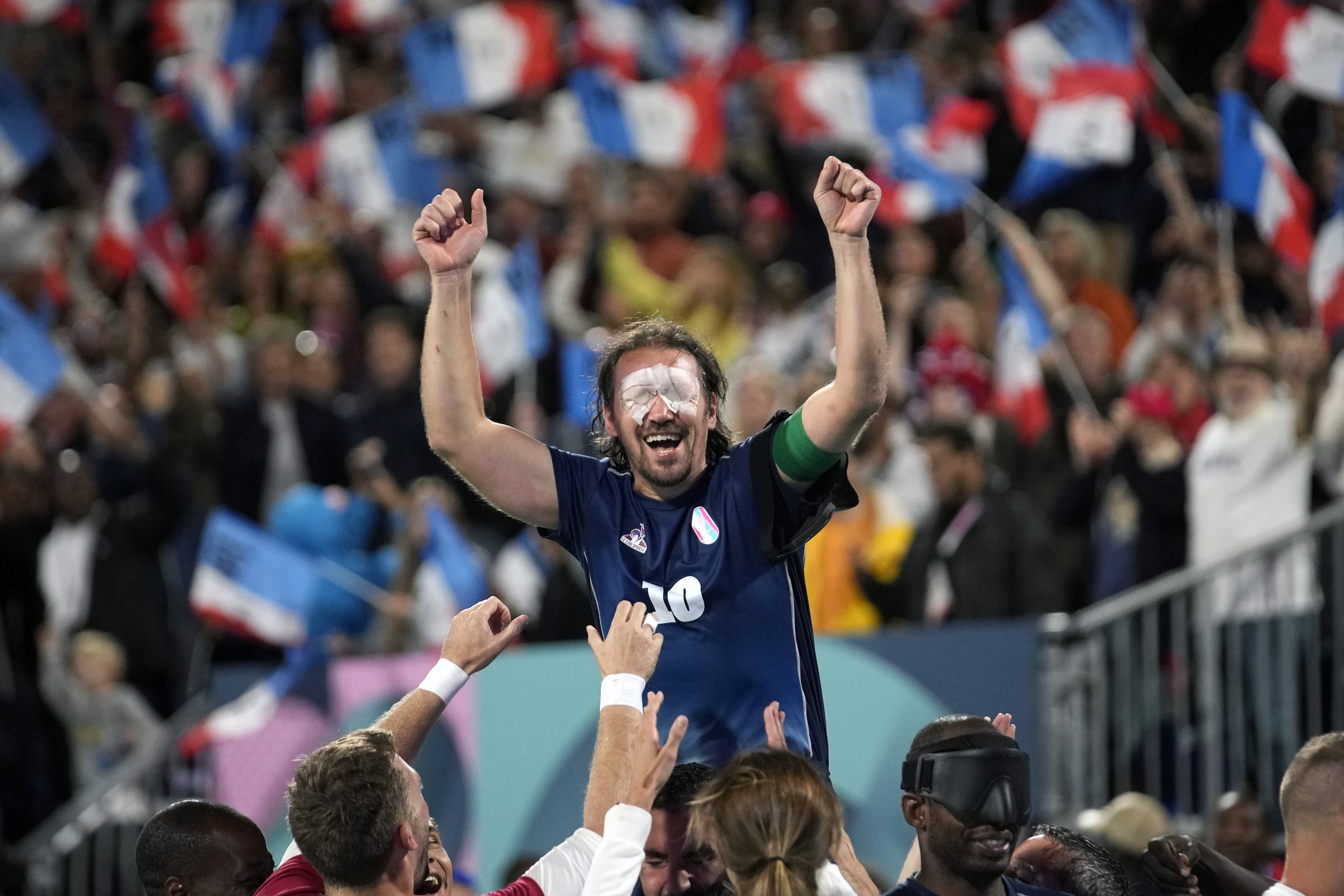 France's captain Frederic Villeroux celebrate after scoring the decisive penalty and winning the blind football gold medal match at the 2024 Paralympics, Saturday, Sept. 7, 2024, in Paris, France. (AP Photo/Christophe Ena)