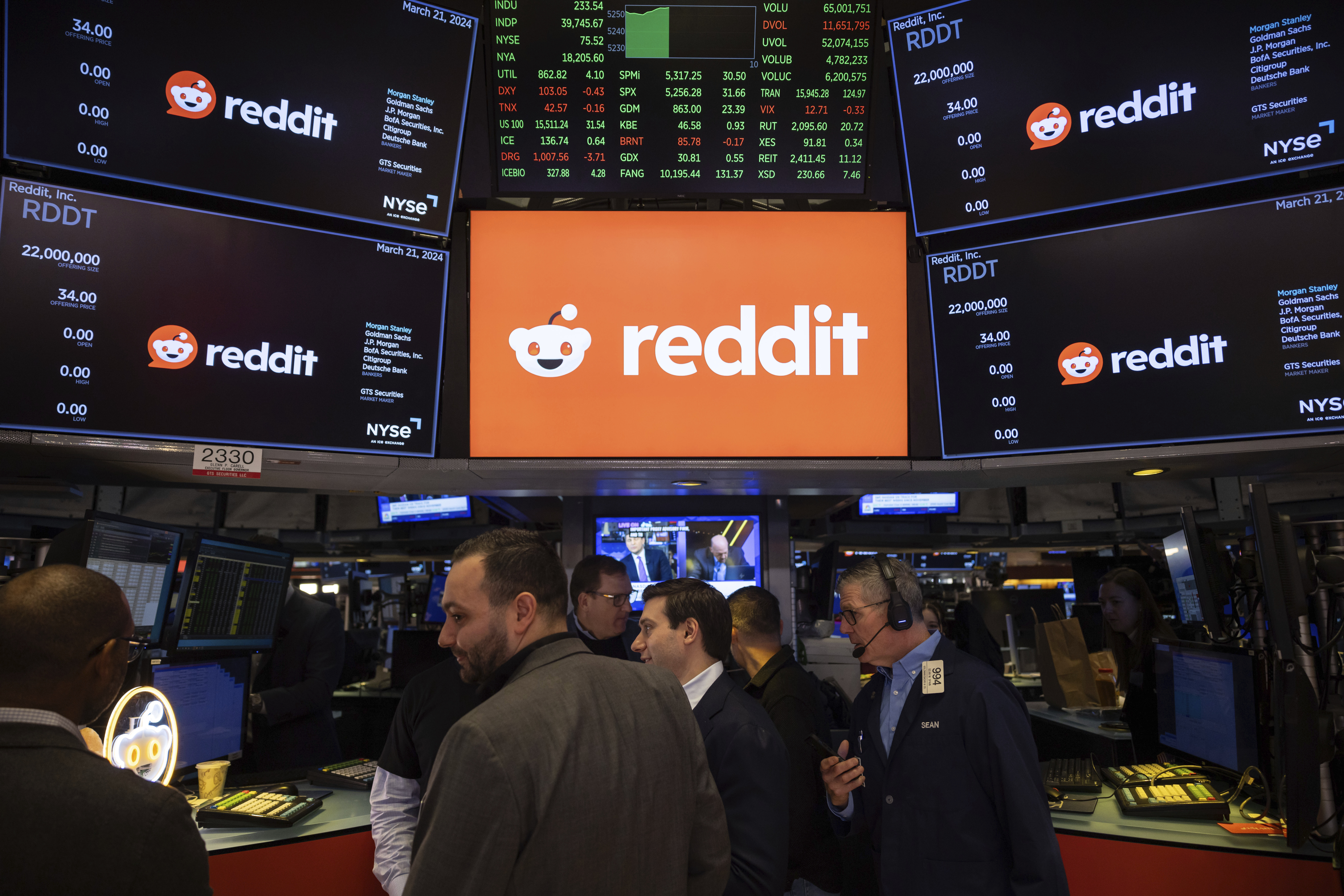 FILE - Reddit Inc. signage is seen on the New York Stock Exchange trading floor, prior to Reddit IPO, Thursday, March. 21, 2024. OpenAI and Reddit are teaming up in a deal that will bring the social media platform's content to ChatGPT. Shares of Reddit jumped 17% before the market open on Friday, May 17. (AP Photo/Yuki Iwamura, File)