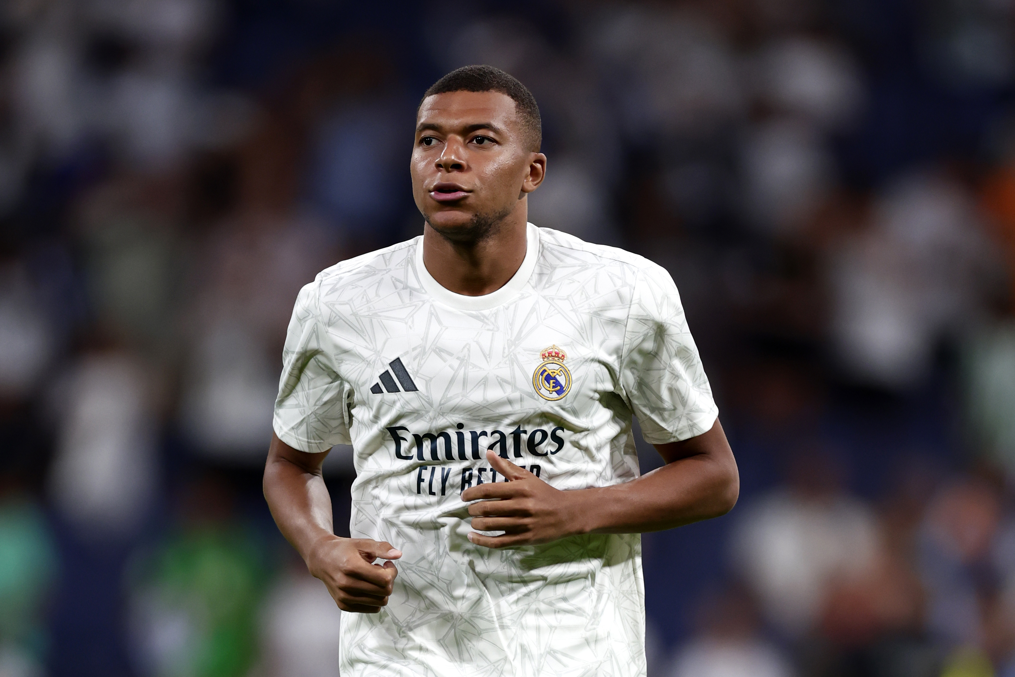 Real Madrid's Kylian Mbappe warms up for the Spanish La Liga soccer match between Real Madrid and Betis at the Santiago Bernabeu stadium in Madrid, Spain, Sunday, Sept. 1, 2024. (AP Photo/Pablo Garcia)