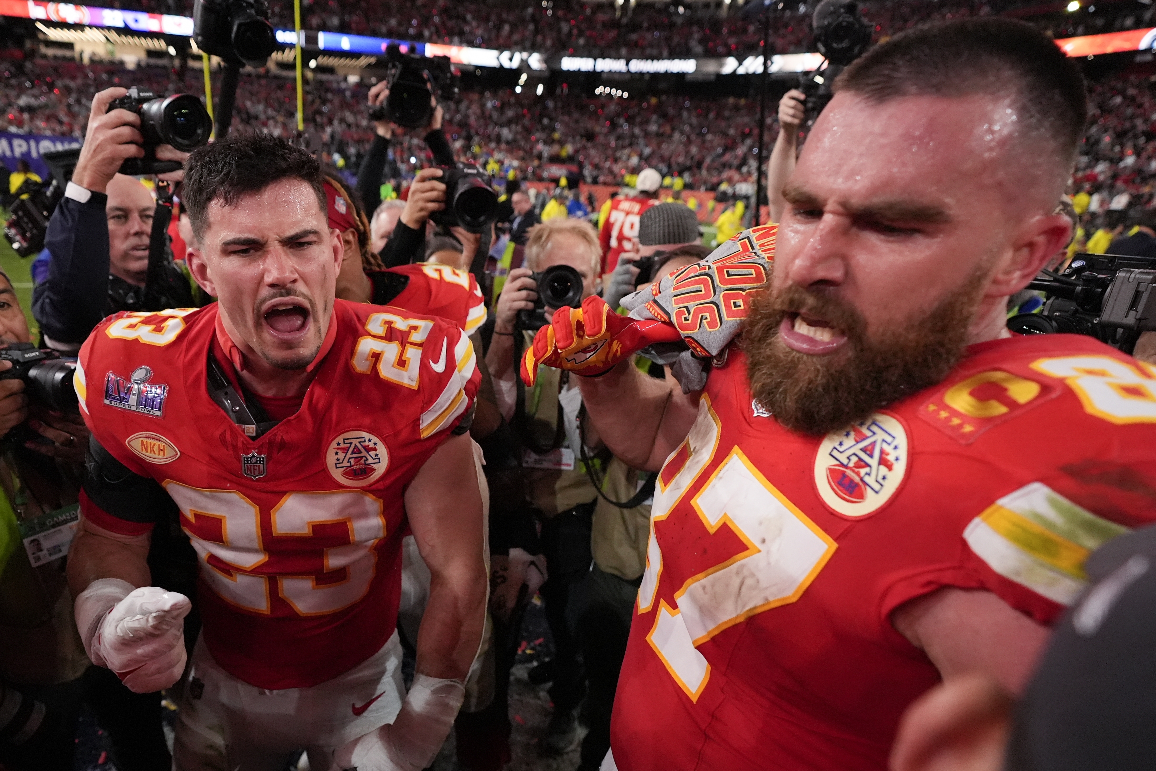 Kansas City Chiefs tight end Travis Kelce (87) and Kansas City Chiefs linebacker Drue Tranquill (23) celebrate after the NFL Super Bowl 58 football game against the San Francisco 49ers on Sunday, Feb. 11, 2024, in Las Vegas. The Kansas City Chiefs won 25-22 against the San Francisco 49ers. (AP Photo/Ashley Landis)