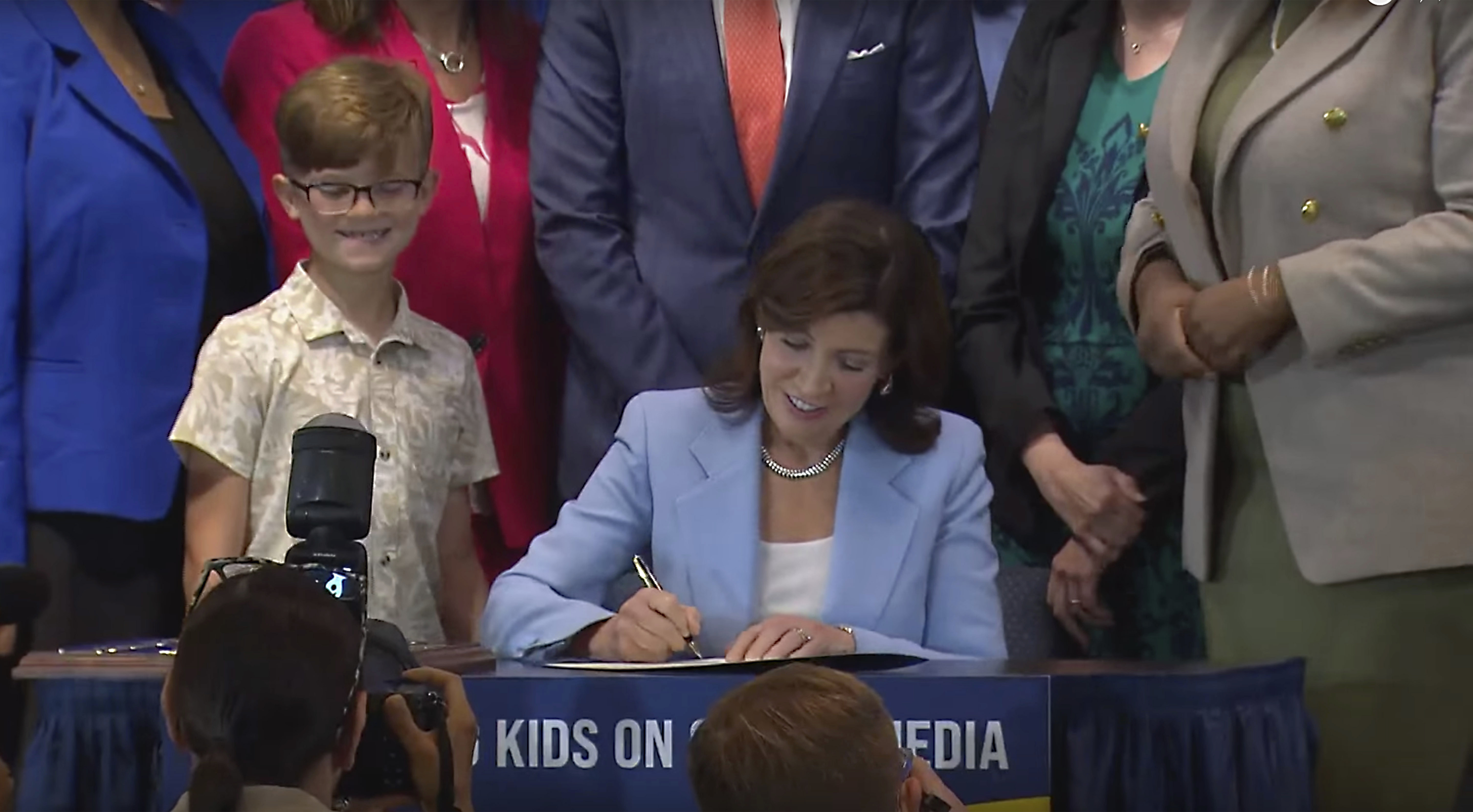 In this still image taken from video of the Office of the New York Governor, Gov. Kathy Hochul signs a bill, in New York, Thursday, June 20, 2024. Hochul signed a bill that would allow parents to block their children from getting social media posts suggested by a platform's algorithm, a move to limit feeds critics argue are addictive. (Office of the New York Governor via AP)