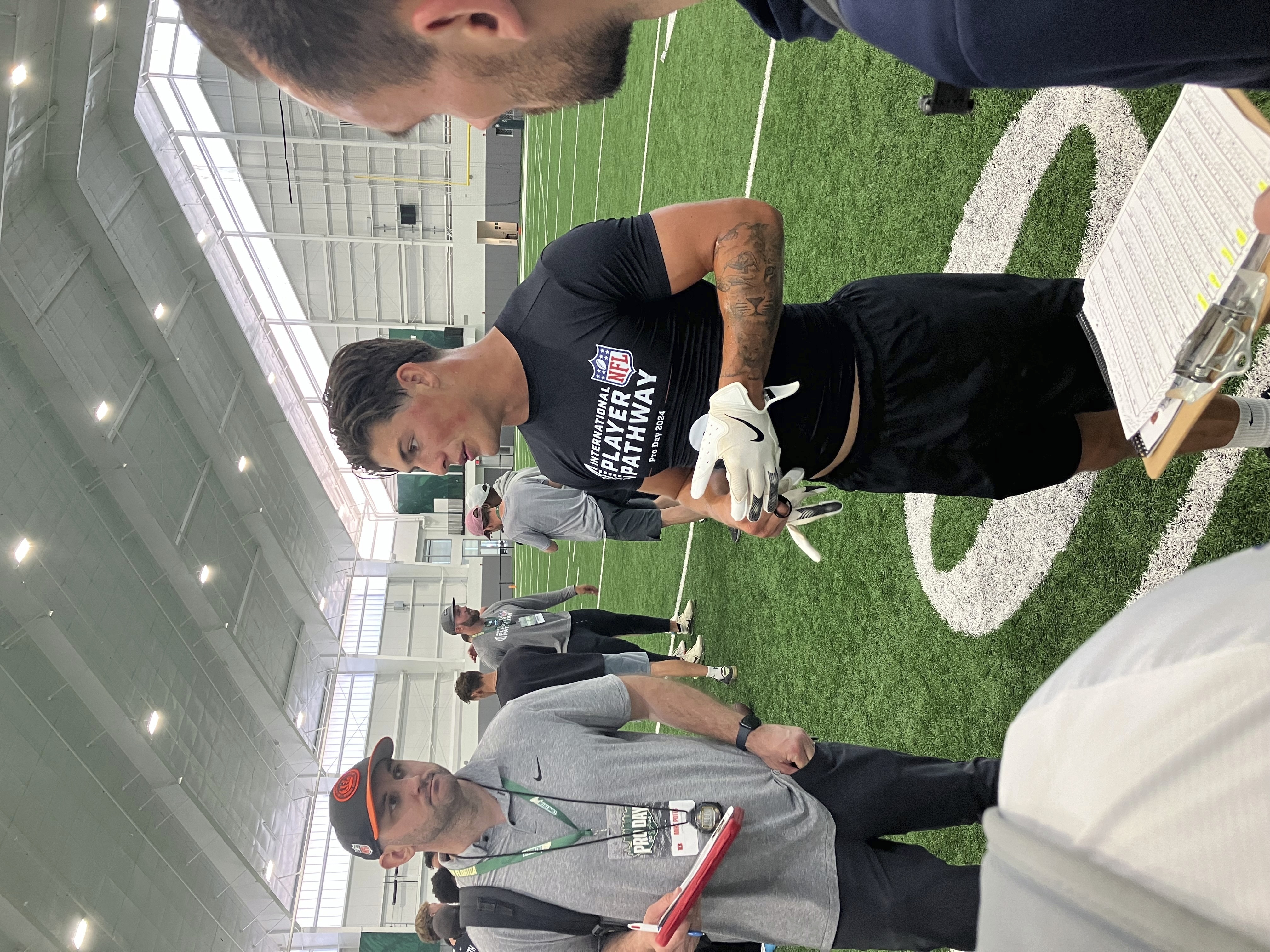 Welsh rugby star Louis Rees-Zammit, center, speaks to NFL scouts following pro day for NFL International Player Pathway prospects held at the University of South Florida on Wednesday, March 20, 2024, in Tampa, Fla. (AP Photo/Rob Maaddi)