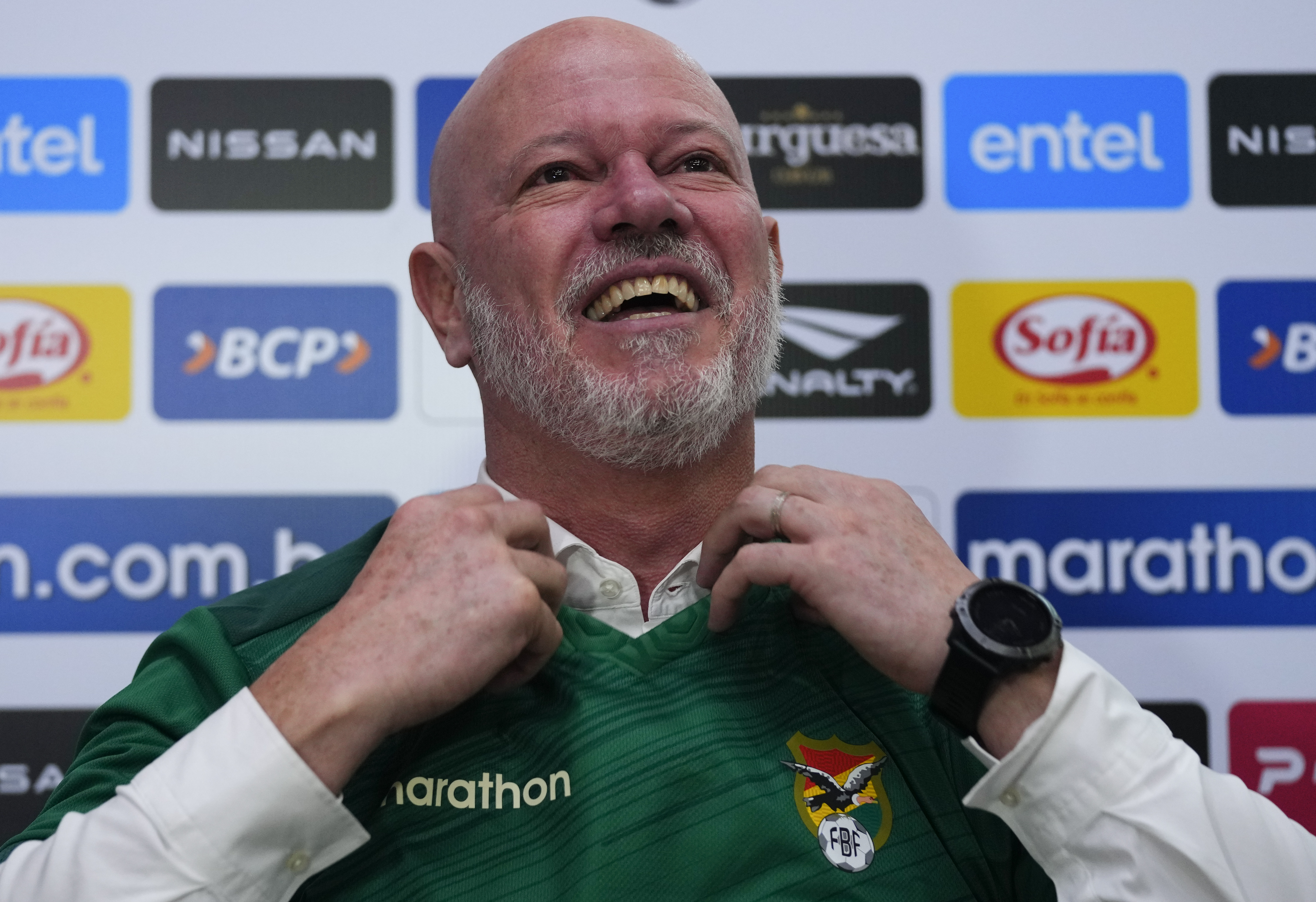 Antonio Zago, of Brazil, puts on a jersey during a signing ceremony where he was made the new head coach of Bolivia's national soccer team in La Paz, Bolivia, Tuesday, Oct. 31, 2023. (AP Photo/Juan Karita)