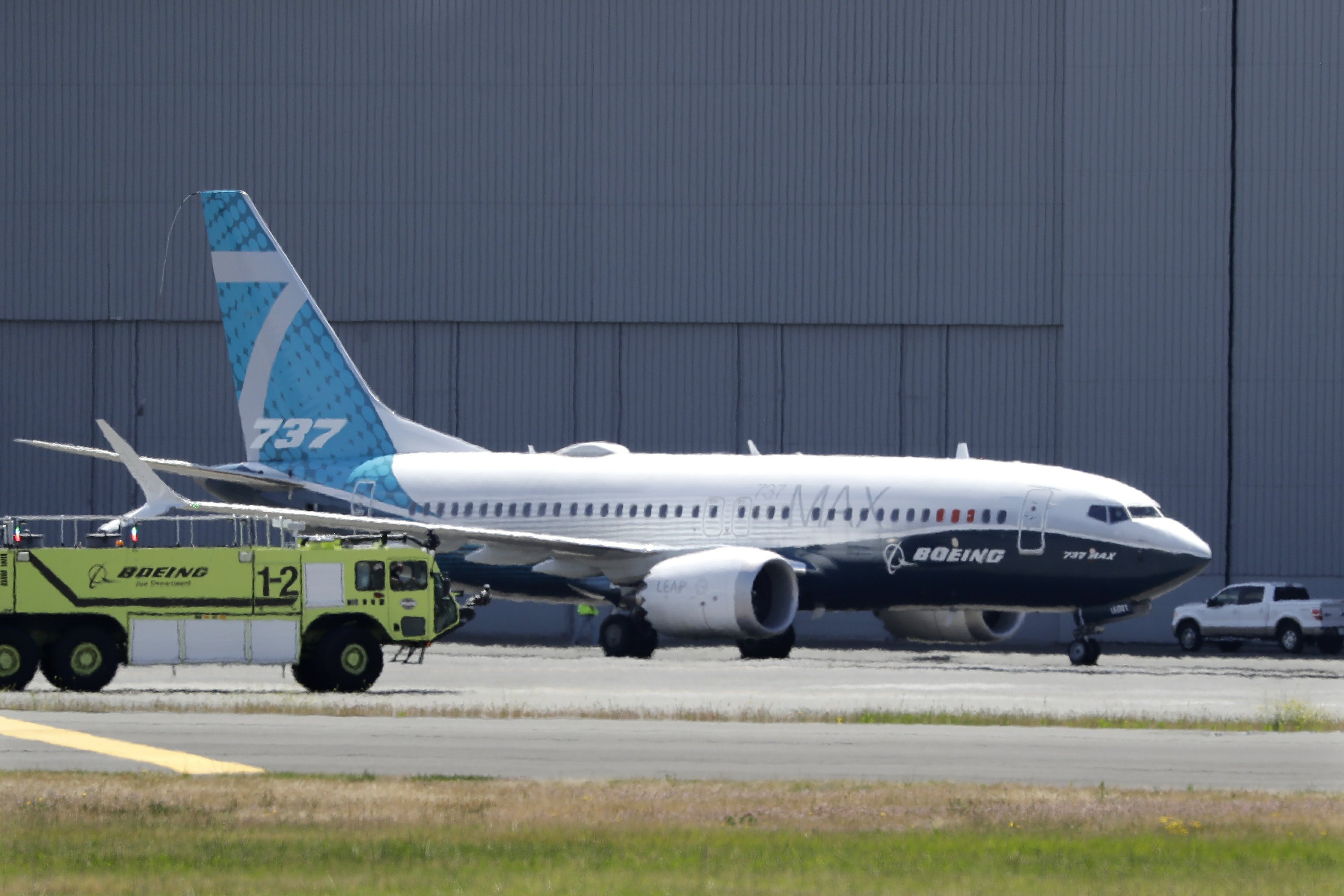 FILE - In this Monday, June 29, 2020, file photo, A Boeing 737 MAX jet taxis after landing at Boeing Field following a test flight in Seattle. Boeing will pay $2.5 billion to settle a criminal charge related to its troubled 737 Max jetliner. The Justice Department announced the settlement Thursday, Jan. 7, 2021 nearly two years after the second of two crashes that killed 346 people in all.  (AP Photo/Elaine Thompson)