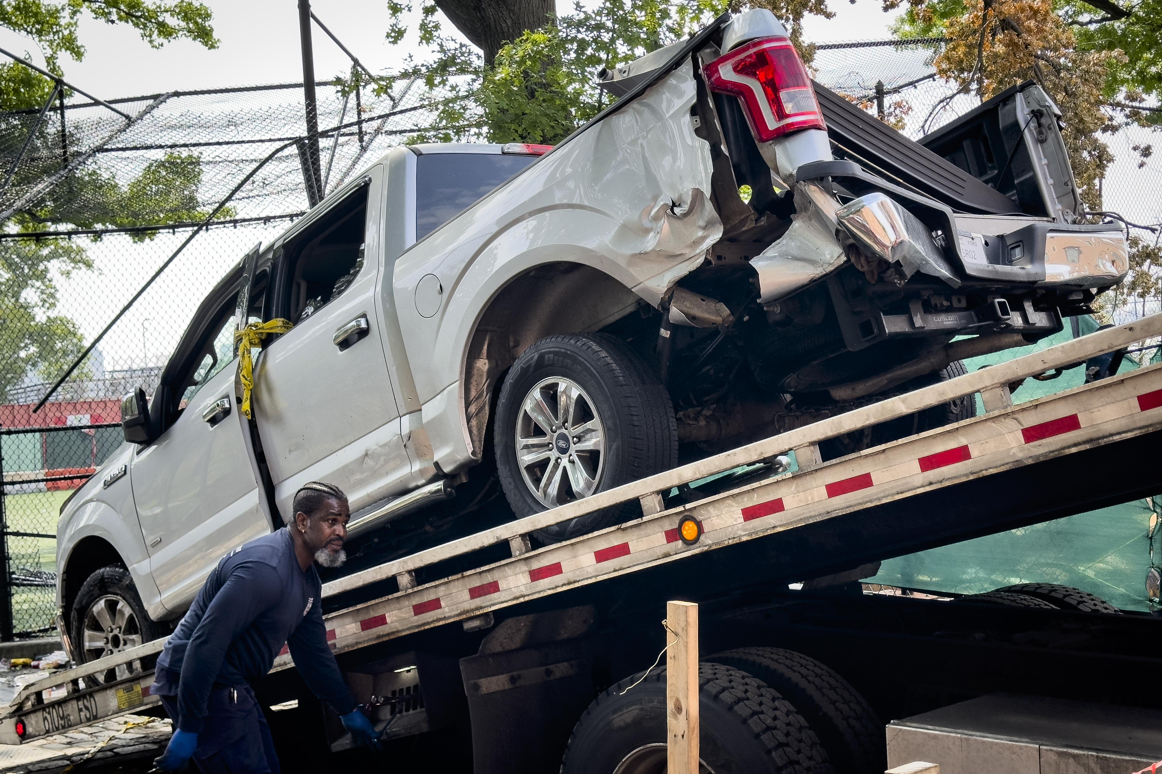 A truck is lifted onto a flatbed as New York City authorities work a crime scene of a deadly crash Friday, July 5, 2024, in the Lower East Side neighborhood in New York. Authorities say a pickup truck drove into a group celebrating the Fourth of July on Thursday night. (AP Photo/John Minchillo)