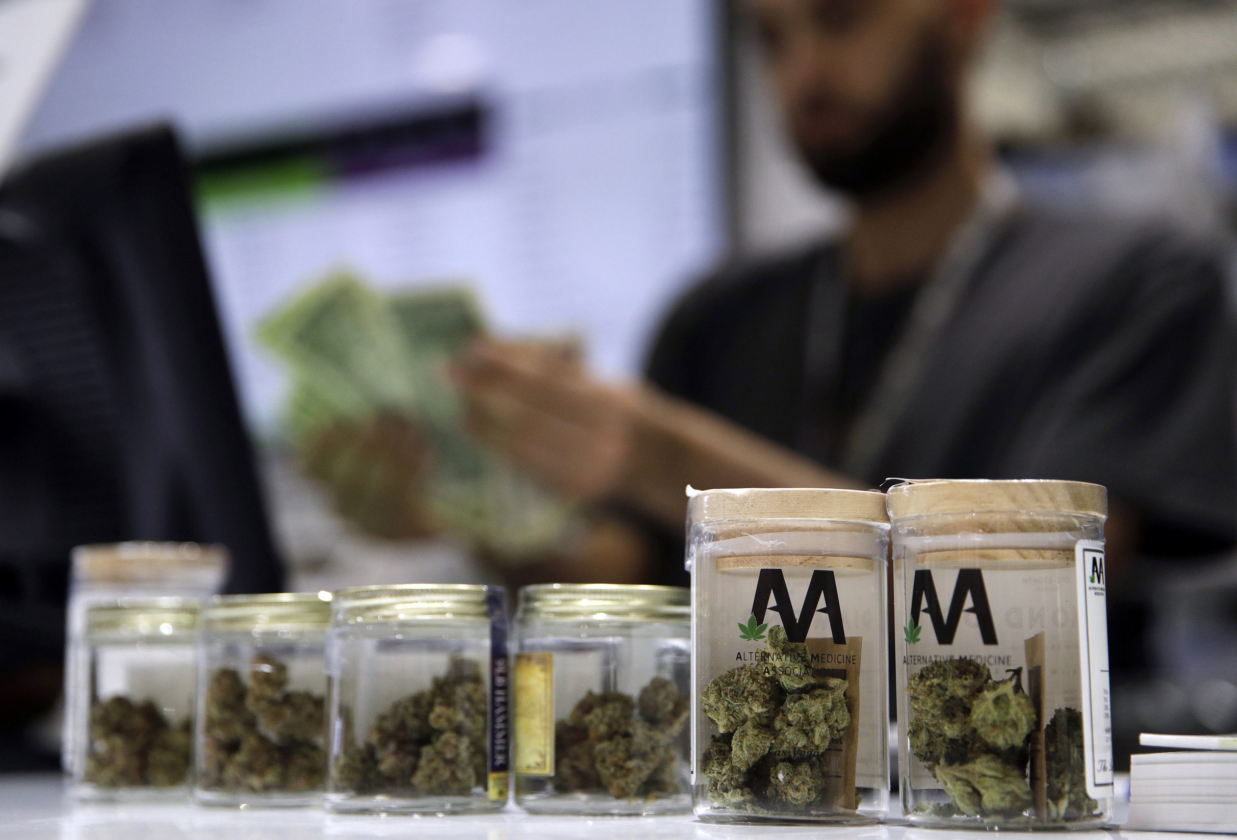 FILE - A cashier rings up a marijuana sale, July 1, 2017, at a cannabis dispensary in Las Vegas. (AP Photo/John Locher, File)