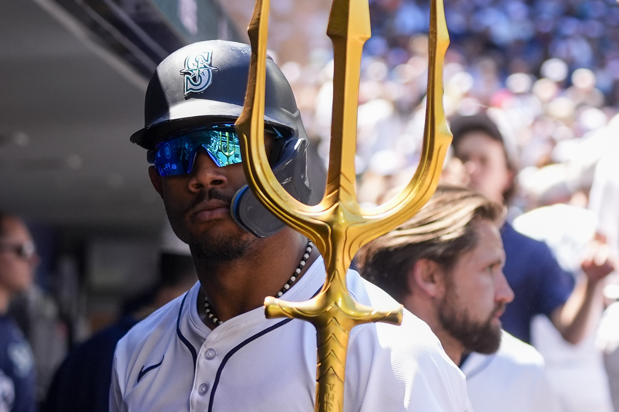 Seattle Mariners' Julio Rodríguez holds a trident in the dugout after his solo home run against the Baltimore Orioles during the fifth inning of a baseball game Thursday, July 4, 2024, in Seattle. (AP Photo/Lindsey Wasson)