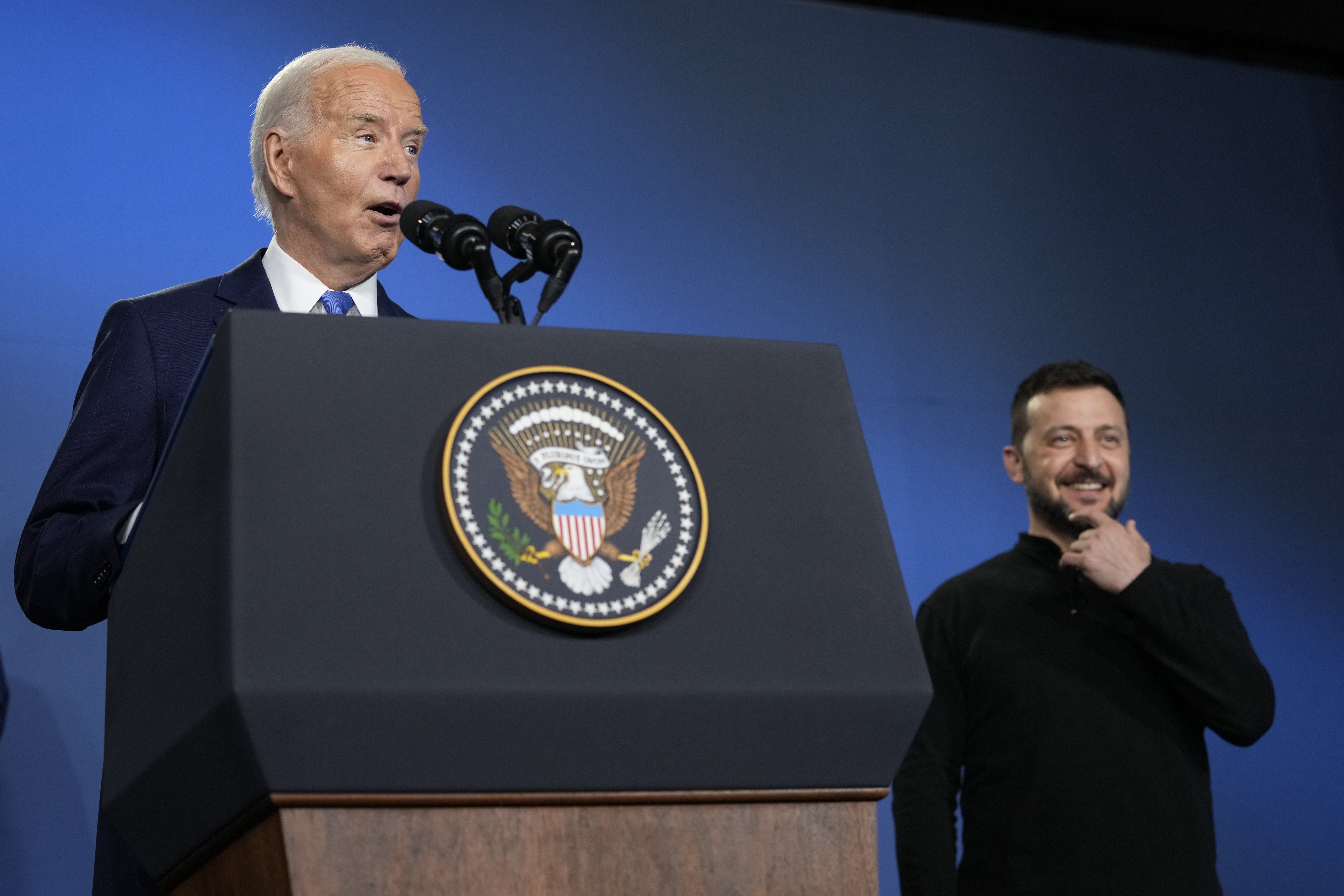 President Joe Biden, joined by President of Ukraine Volodymyr Zelenskyy, speaks during an event on the Ukraine Compact on the sidelines of the NATO Summit in Washington, Thursday, July 11, 2024. Biden launched the Ukraine Compact, signed by 25 countries and the European Union, as part of a commitment to Ukraine's long term security. (AP Photo/Susan Walsh)