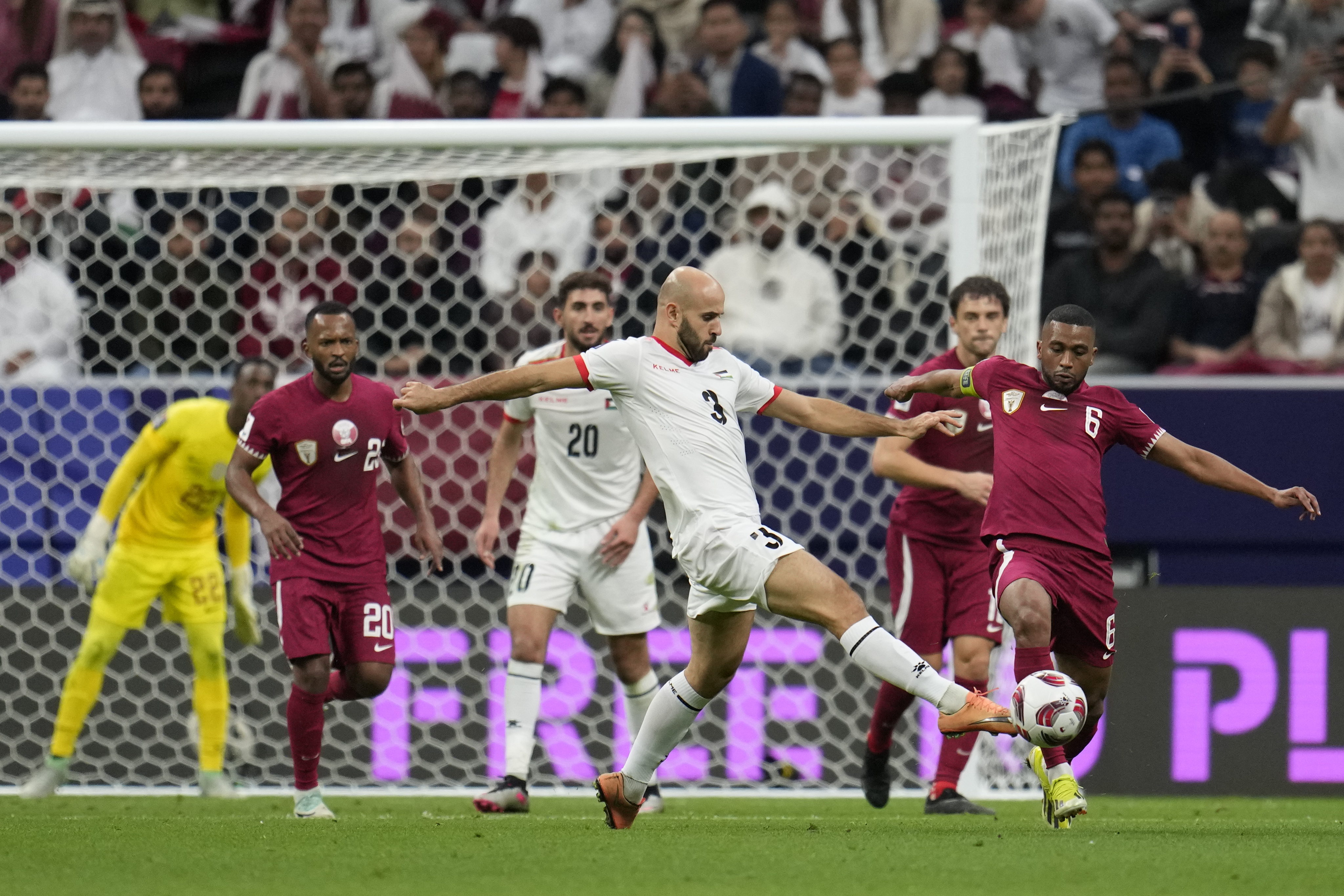 FILE - Palestine's Mohammed Rashid (3) and Qatar's Abdel Aziz Hatim compete for the ball during the Asian Cup round of 16 soccer match between Qatar and Palestine at Al Bayt Stadium in Al Khor, Qatar, Monday, Jan. 29, 2024. Rashid once worked as a forklift driver in a Chicago warehouse (AP Photo/Aijaz Rahi, File)