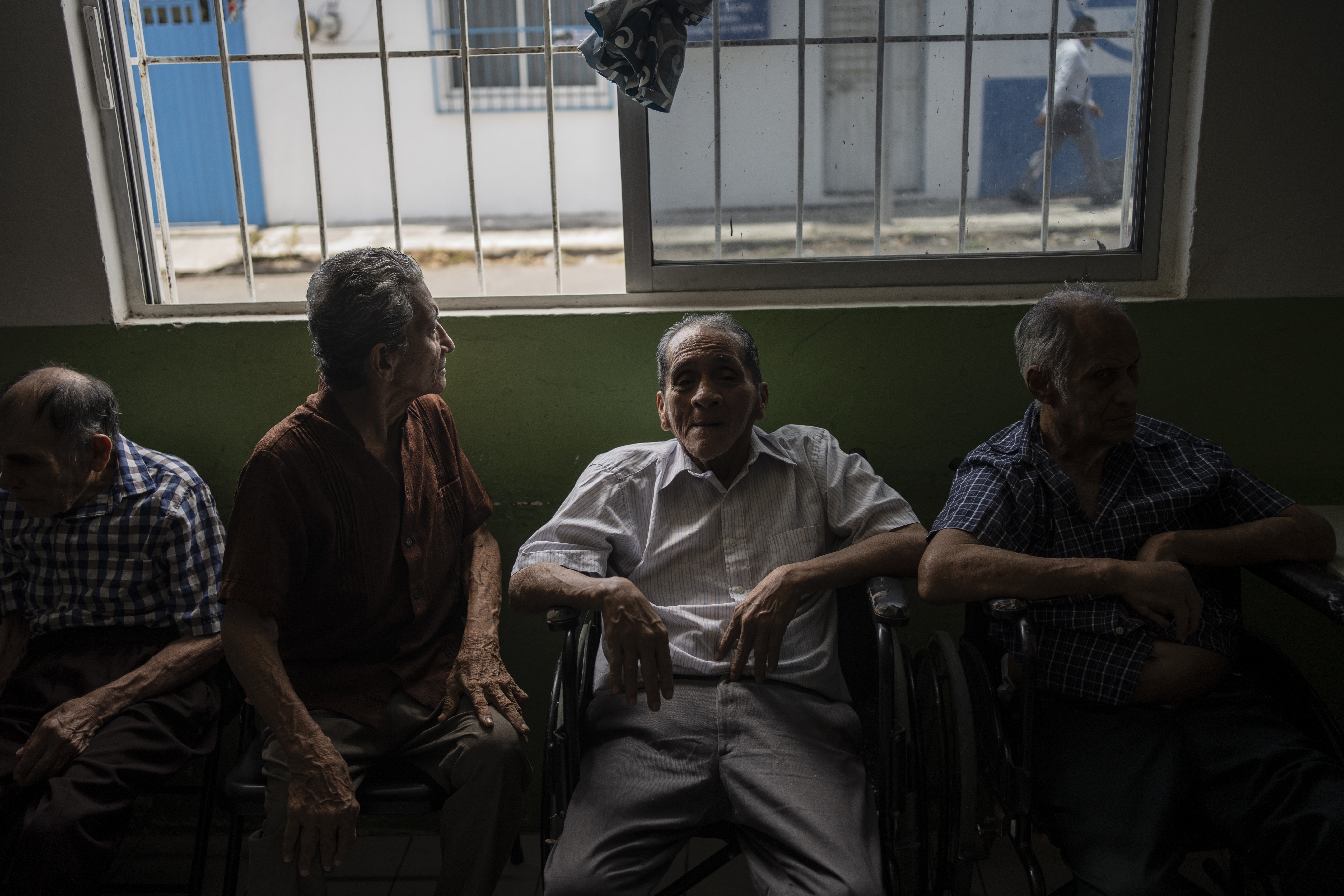 Claudio Melchor, Manuel Cervantes and Javier Rojas sit by the window of the Cogra, an elderly shelter, to cool off from the high temperatures in Veracruz, Mexico, on June 16, 2024. Human-caused climate change intensified and made far more likely this month's killer heat with triple digit temperatures, a new flash study found Thursday, June 20. (AP Photo/Felix Marquez)