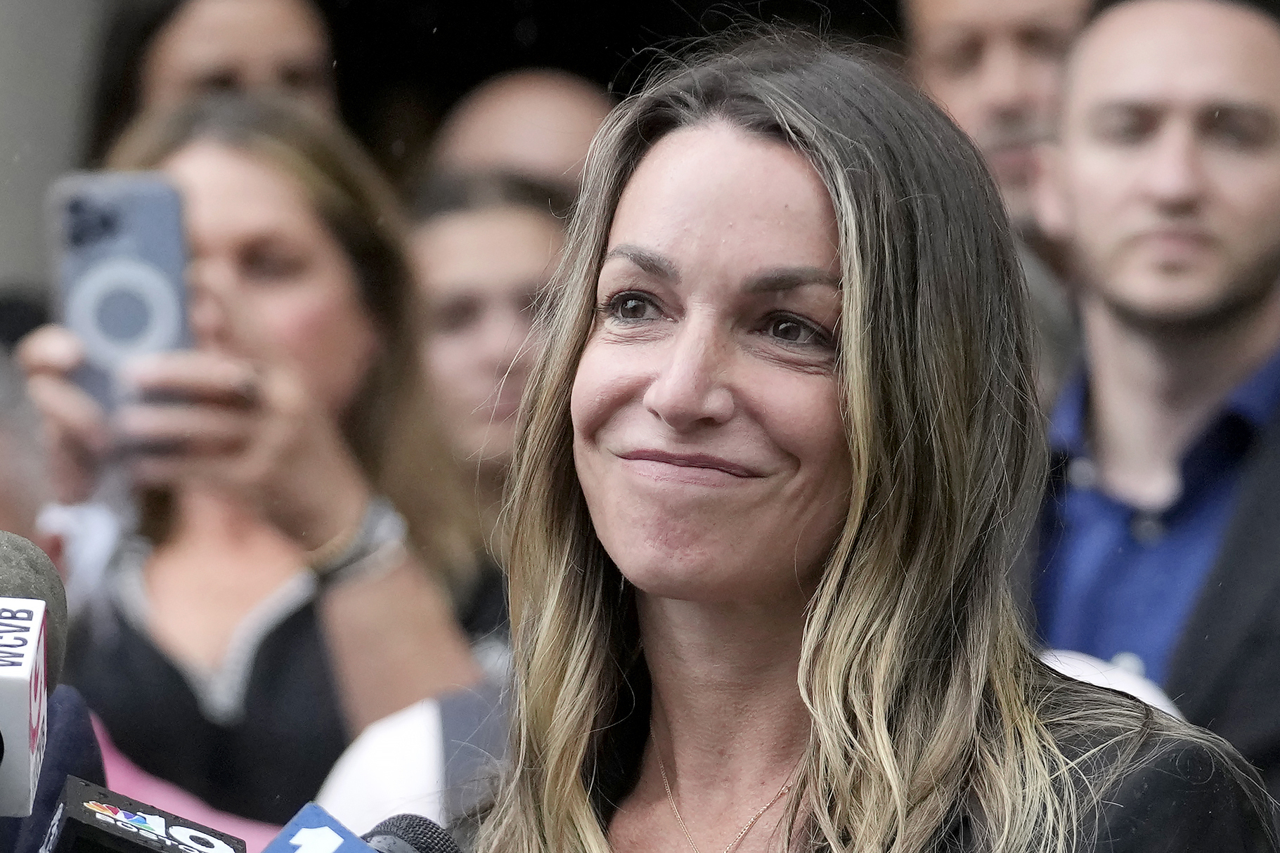 FILE - Karen Read smiles during a news conference in front of Norfolk Superior Court, Monday, July 1, 2024, in Dedham, Mass. Prosecutors in the Read murder case filed a motion Friday, July 12, arguing against dropping any charges in the case. (AP Photo/Steven Senne, File)