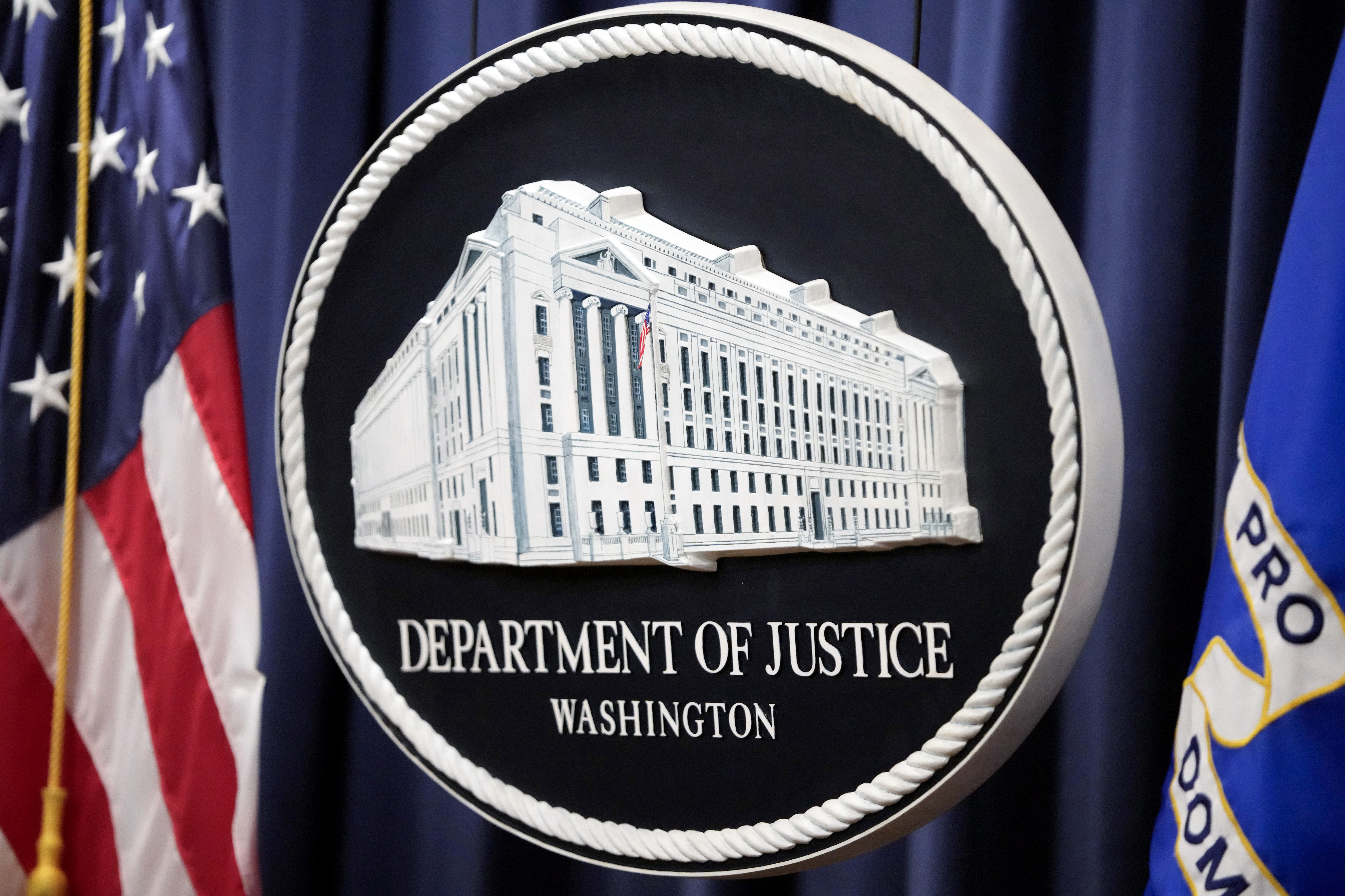 The logo for the Justice Department is seen before a news conference at the Department of Justice, Friday, Aug. 23, 2024, in Washington. (AP Photo/Mark Schiefelbein)