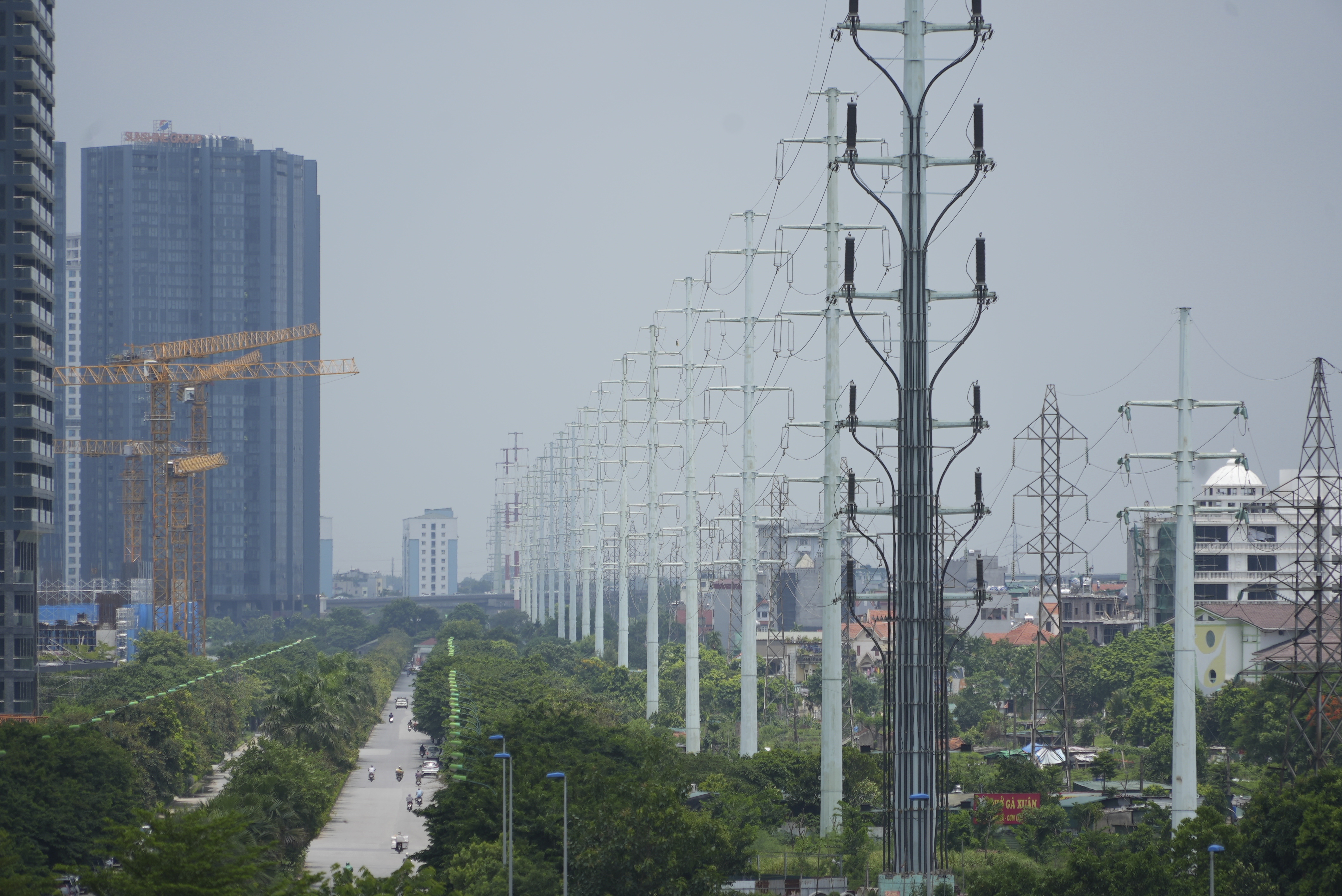 This photo shows power lines in Hanoi, Vietnam, Tuesday, July 9, 2024. Vietnam will let electricity-guzzling factories buy electricity from wind and solar power producers, helping big companies like Samsung Electronics meet their climate targets and relieving pressure on the country's overstrained grid. (AP Photo/Hau Dinh)