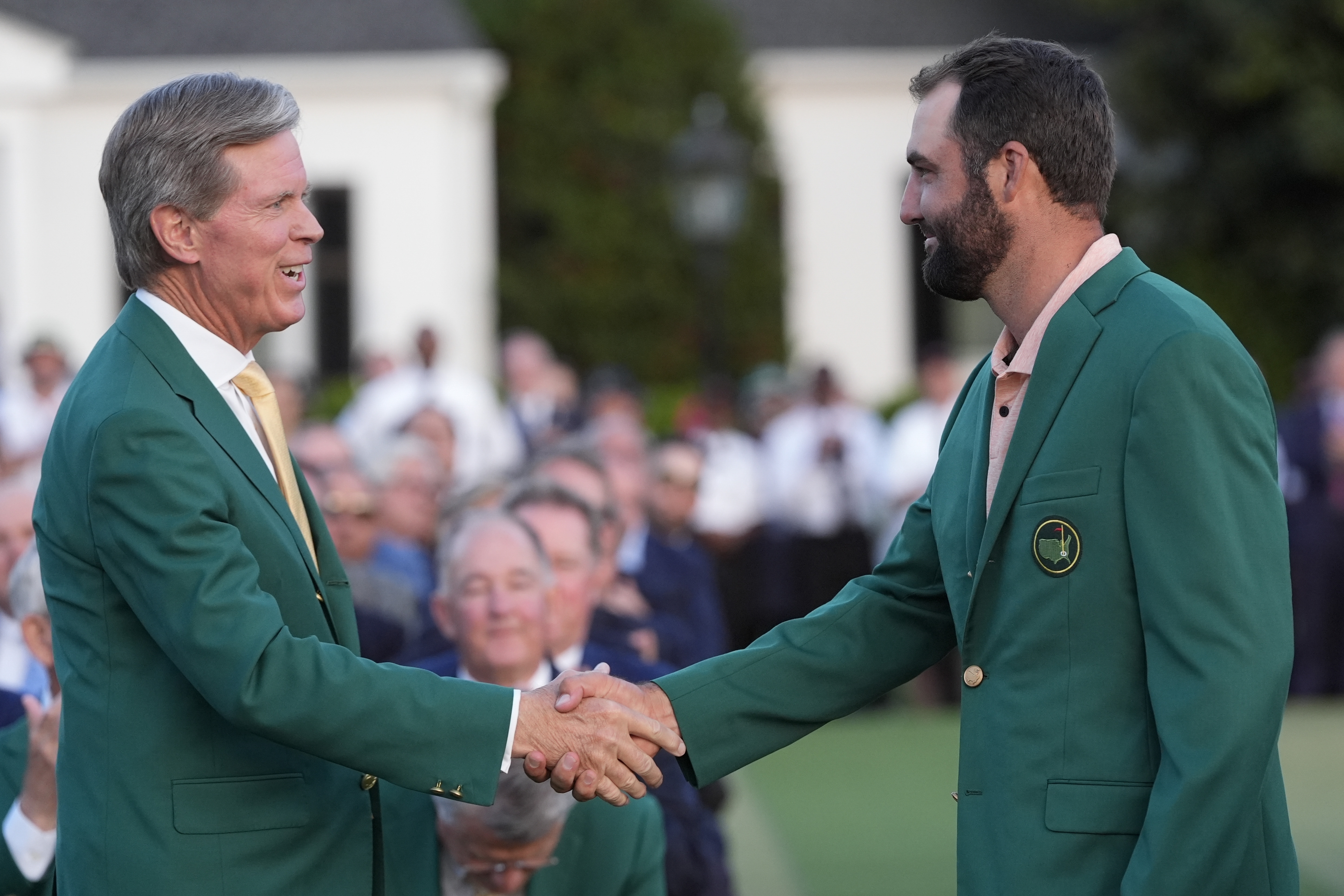 FILE - Fred Ridley, chairman of Augusta National Golf Club, shakes hands with Winner Scottie Scheffler at the Masters golf tournament at Augusta National Golf Club Sunday, April 14, 2024, in Augusta, Ga. (AP Photo/David J. Phillip, File)