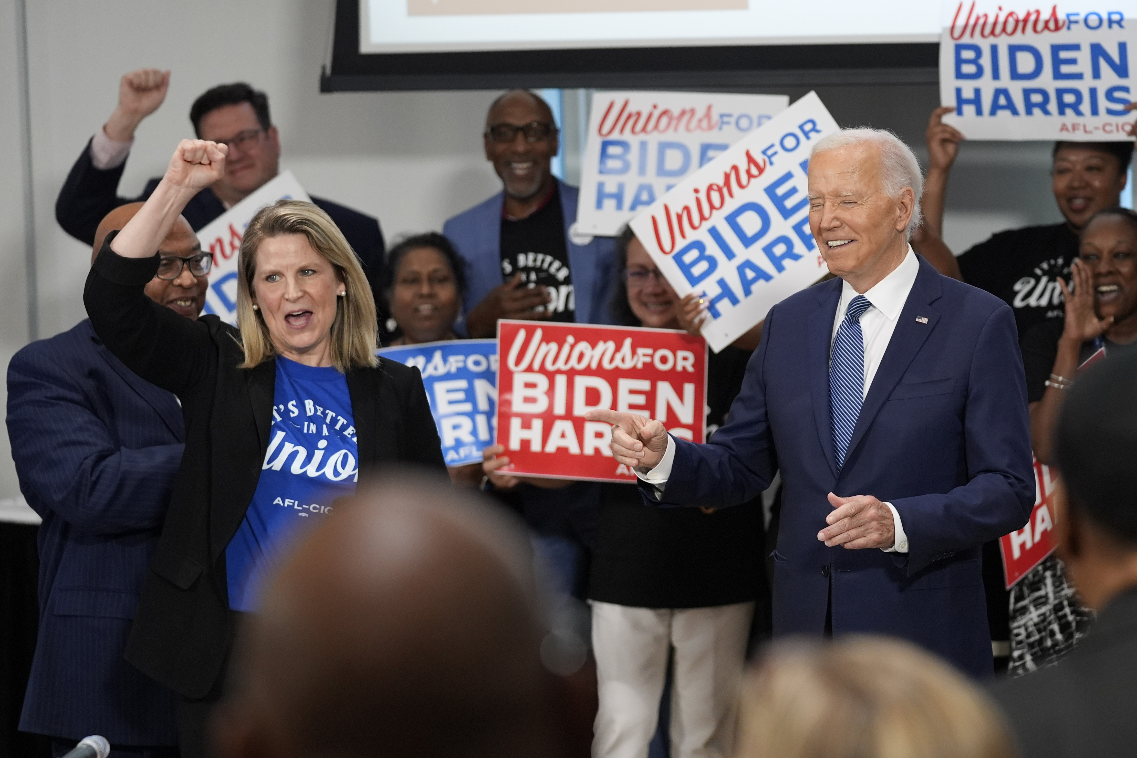 President Joe Biden arrives for a visit to AFL-CIO headquarters, Wednesday, July 10, 2024, in Washington, as AFL-CIO president Liz Shuler, left, cheers. (AP Photo/Evan Vucci)