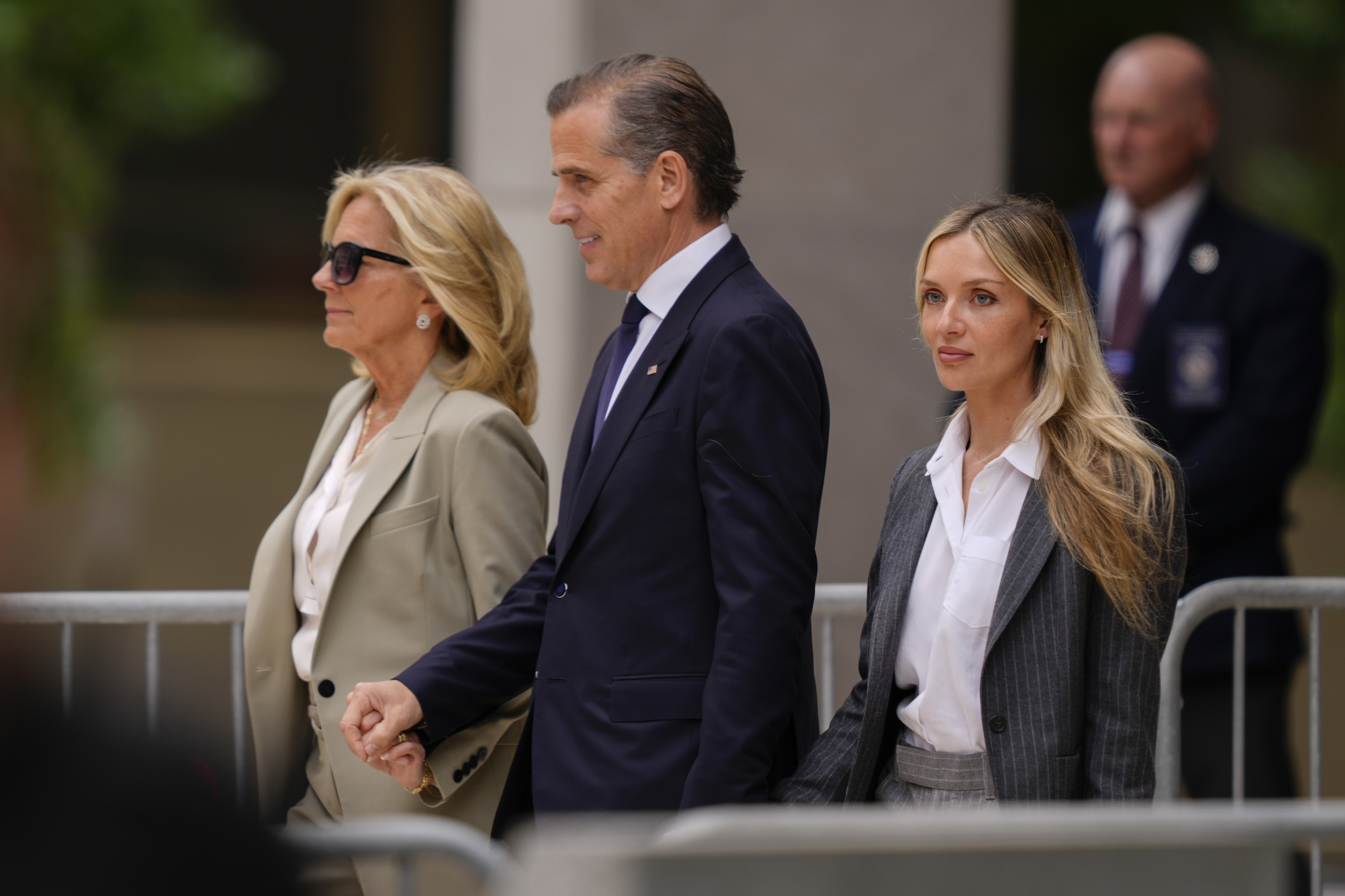 Hunter Biden, center, President Joe Biden's son, accompanied by his mother, first lady Jill Biden, left, and his wife, Melissa Cohen Biden, right, walking out of federal court after hearing the verdict, Tuesday, June 11, 2024, in Wilmington, Del. Hunter Biden has been convicted of all 3 felony charges in the federal gun trial. (AP Photo/Matt Rourke)