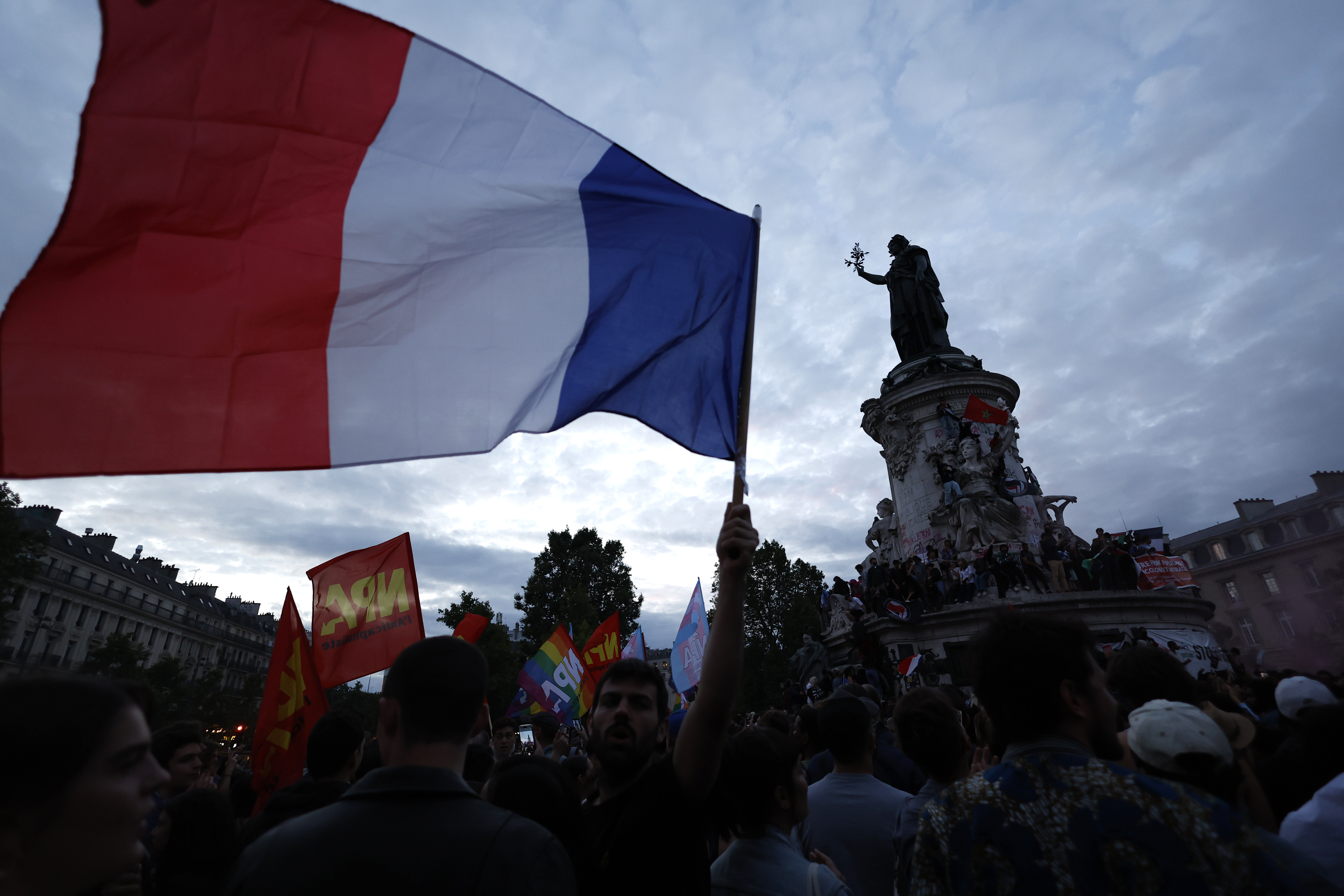 People gather on the Republique plaza following the second round of the legislative elections, Sunday, July 7, 2024 in Paris. A coalition of the French left that quickly banded together to beat a surging far right in legislative elections won the most seats in parliament but not a majority, according to polling projections Sunday, a stunning outcome that threatens to plunge the country into political and economic turmoil. (AP Photo/Aurelien Morissard)