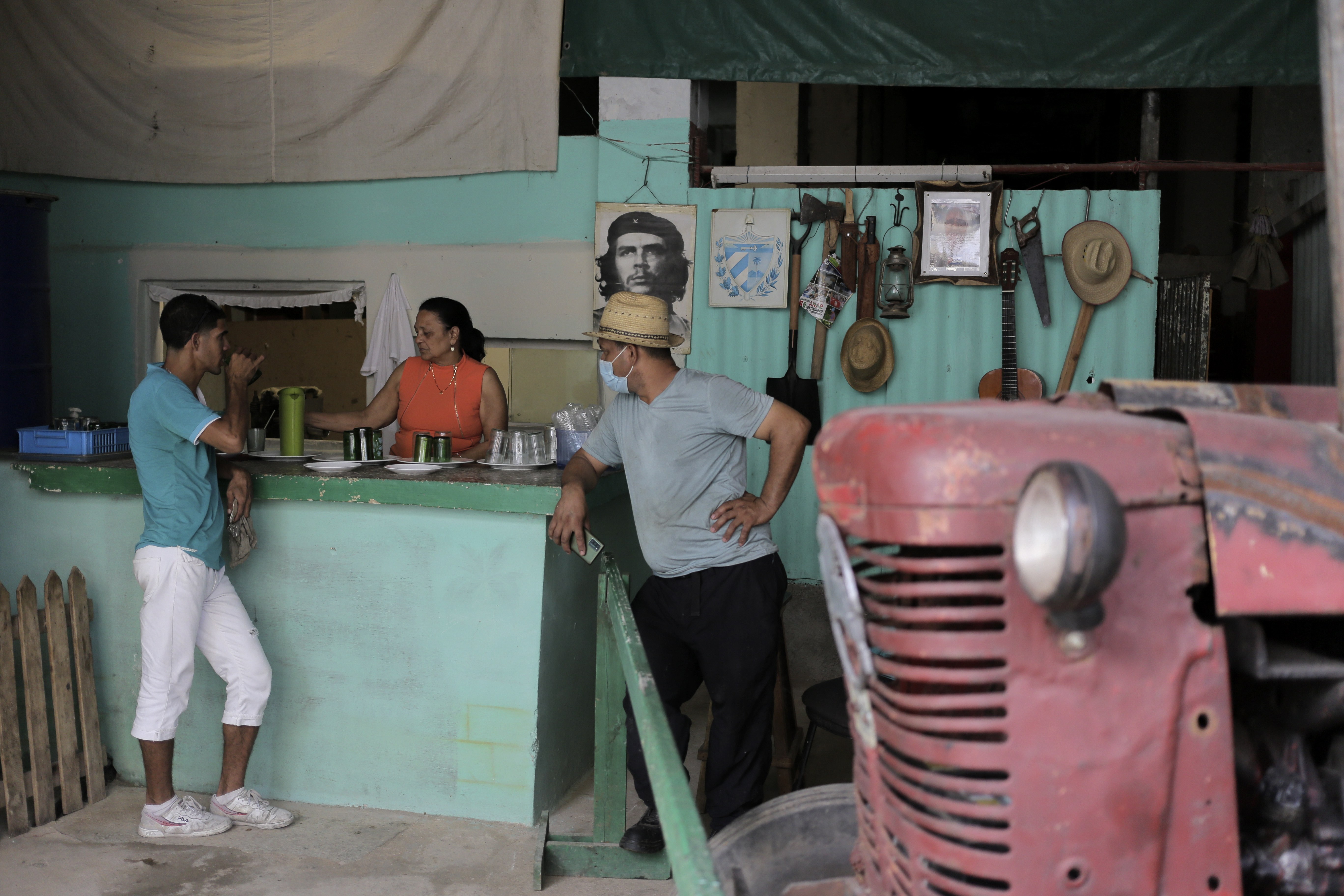 A person drinks juice at a juice bar co-op, in Havana, Cuba, Monday, March 11, 2024. Almost half a million Cubans have gone to the U.S. over the last two years, with thousands more heading to Europe. The economic crisis has led to a dramatic reduction in the availability of rationed food for those who do not leave. (AP Photo/Ariel Ley)