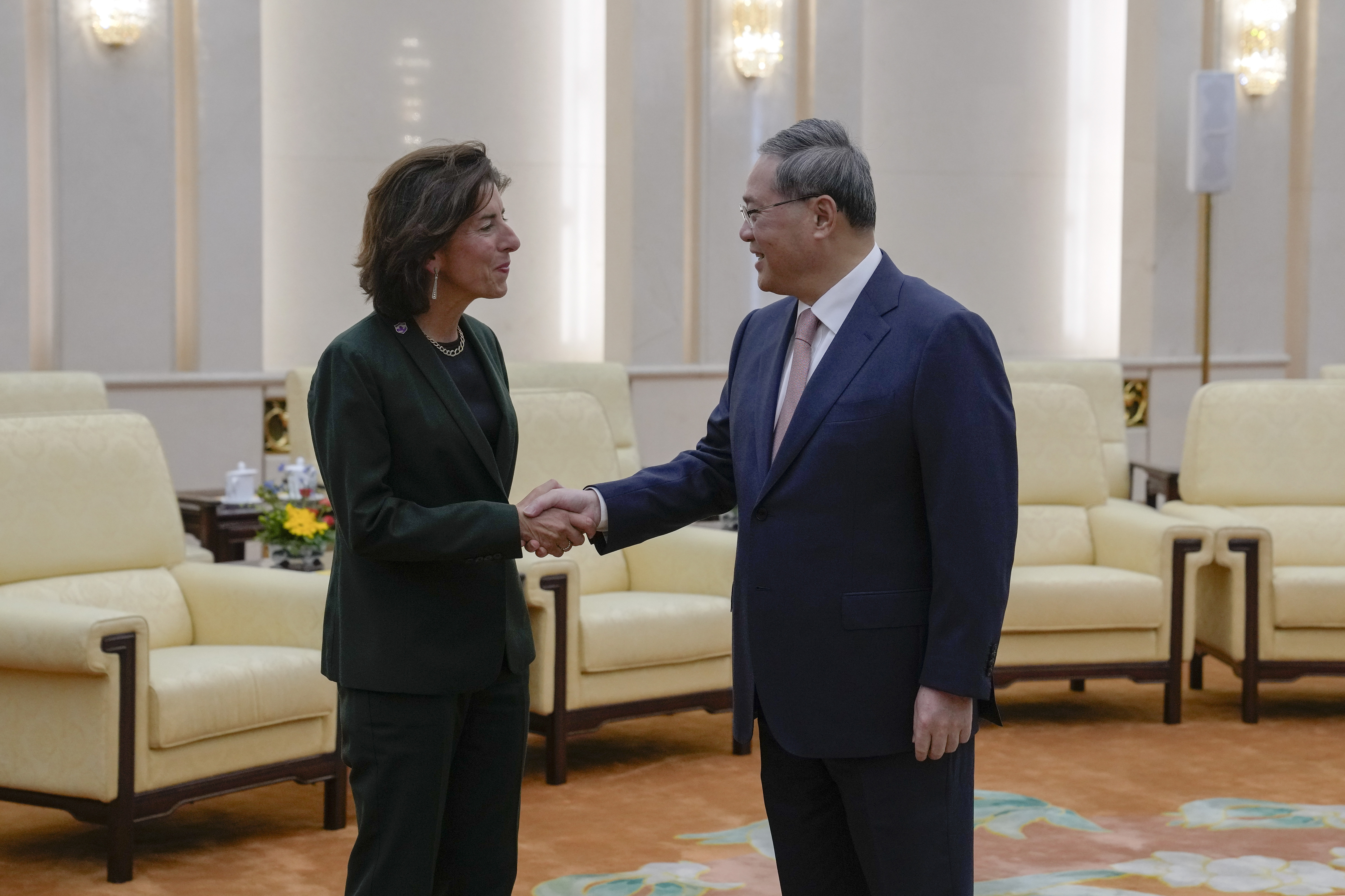 U.S. Commerce Secretary Gina Raimondo, left, is greeted by Chinese Premier Li Qiang at the Great Hall of the People in Beijing, Tuesday, Aug. 29, 2023. (AP Photo/Andy Wong, Pool)