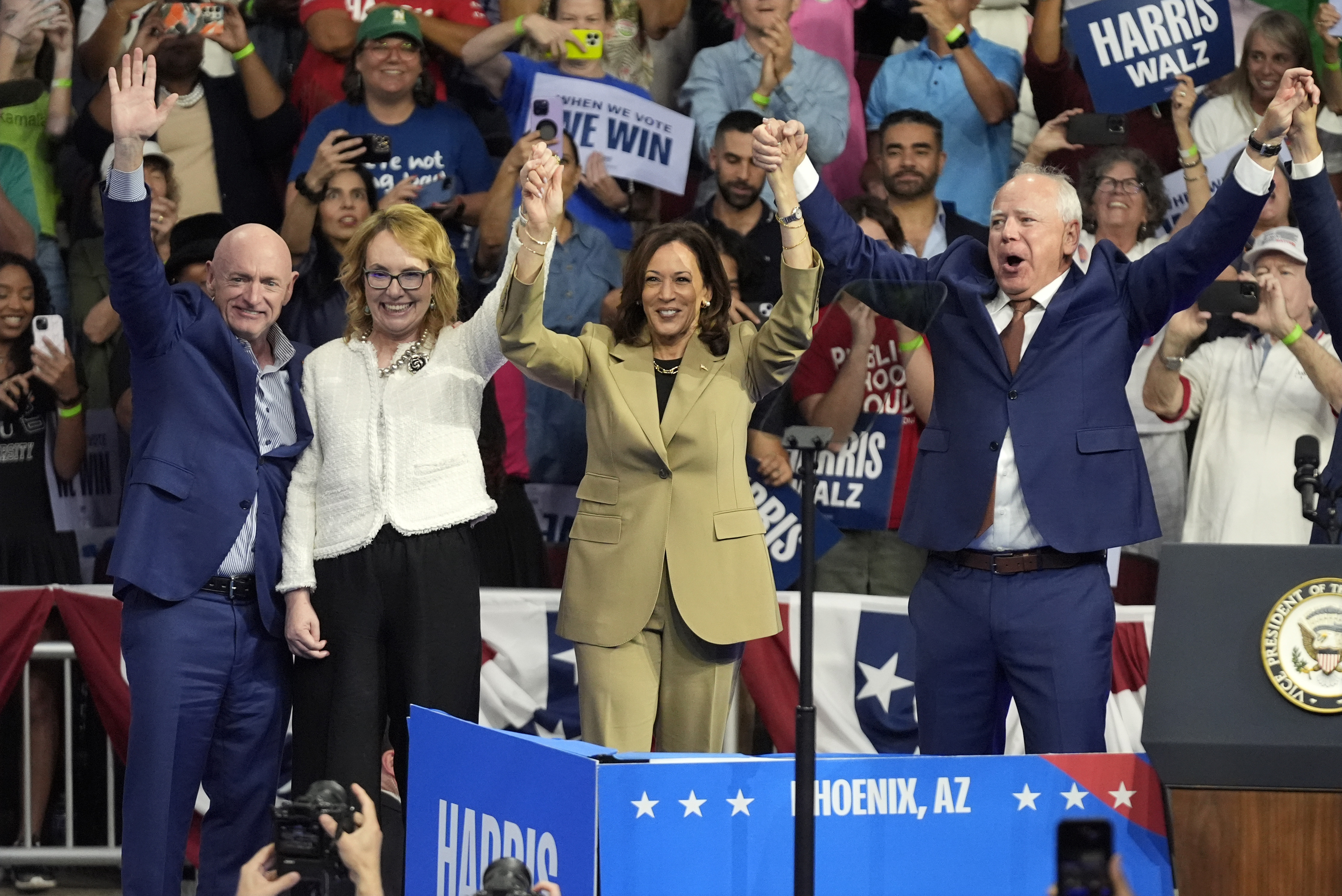 Democratic presidential nominee Vice President Kamala Harris and running mate Minnesota Gov. Tim Walz stand on stage with from left, Sen. Mark Kelly, D-Ariz., and his wife former Rep. Gabby Giffords, at a campaign rally at Desert Diamond Arena, Friday, Aug. 9, 2024, in Glendale, Ariz. (AP Photo/Ross D. Franklin)