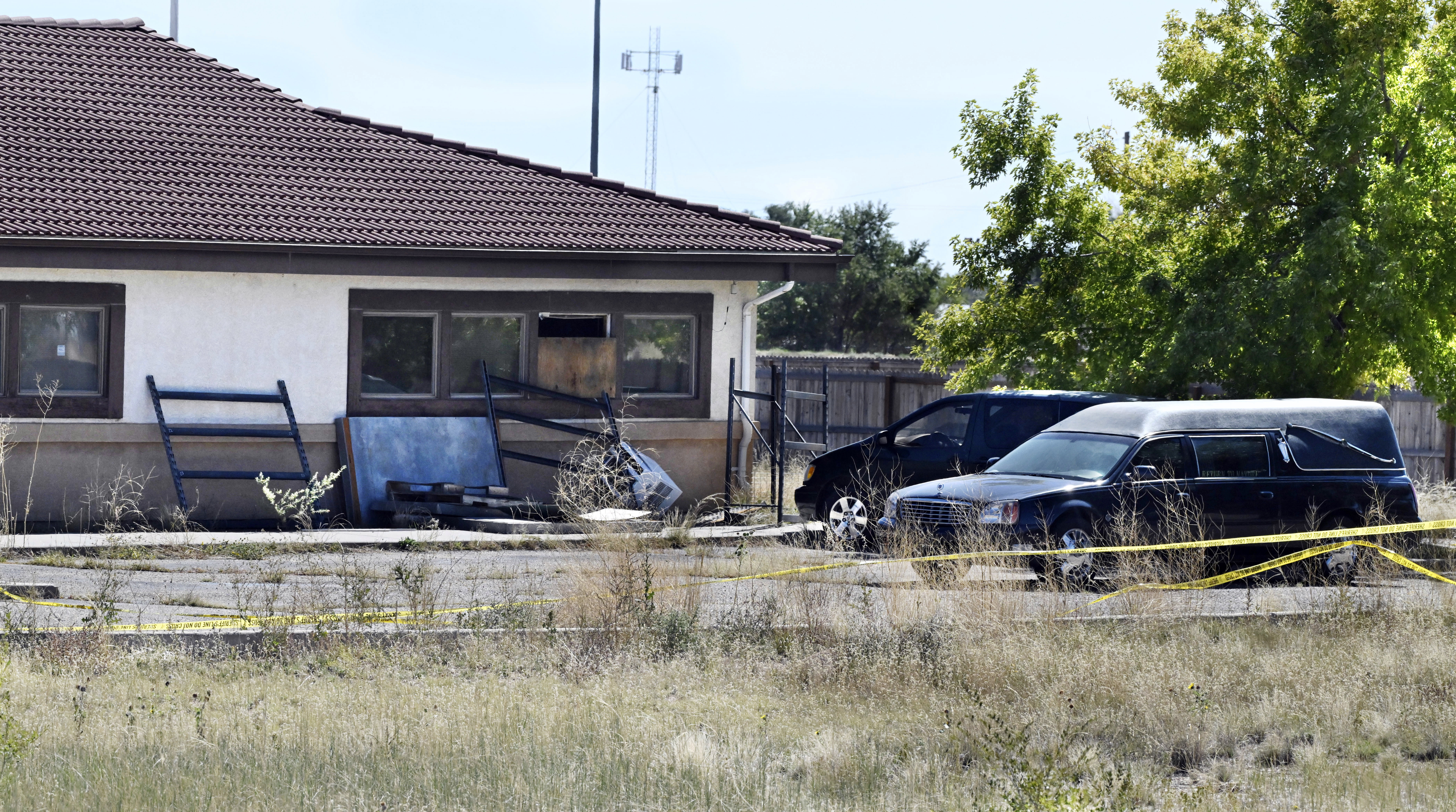 FILE - A hearse and debris sit behind the Return to Nature Funeral Home in Penrose, Colo., on Oct. 5, 2023. (Jerilee Bennett/The Gazette via AP, File)