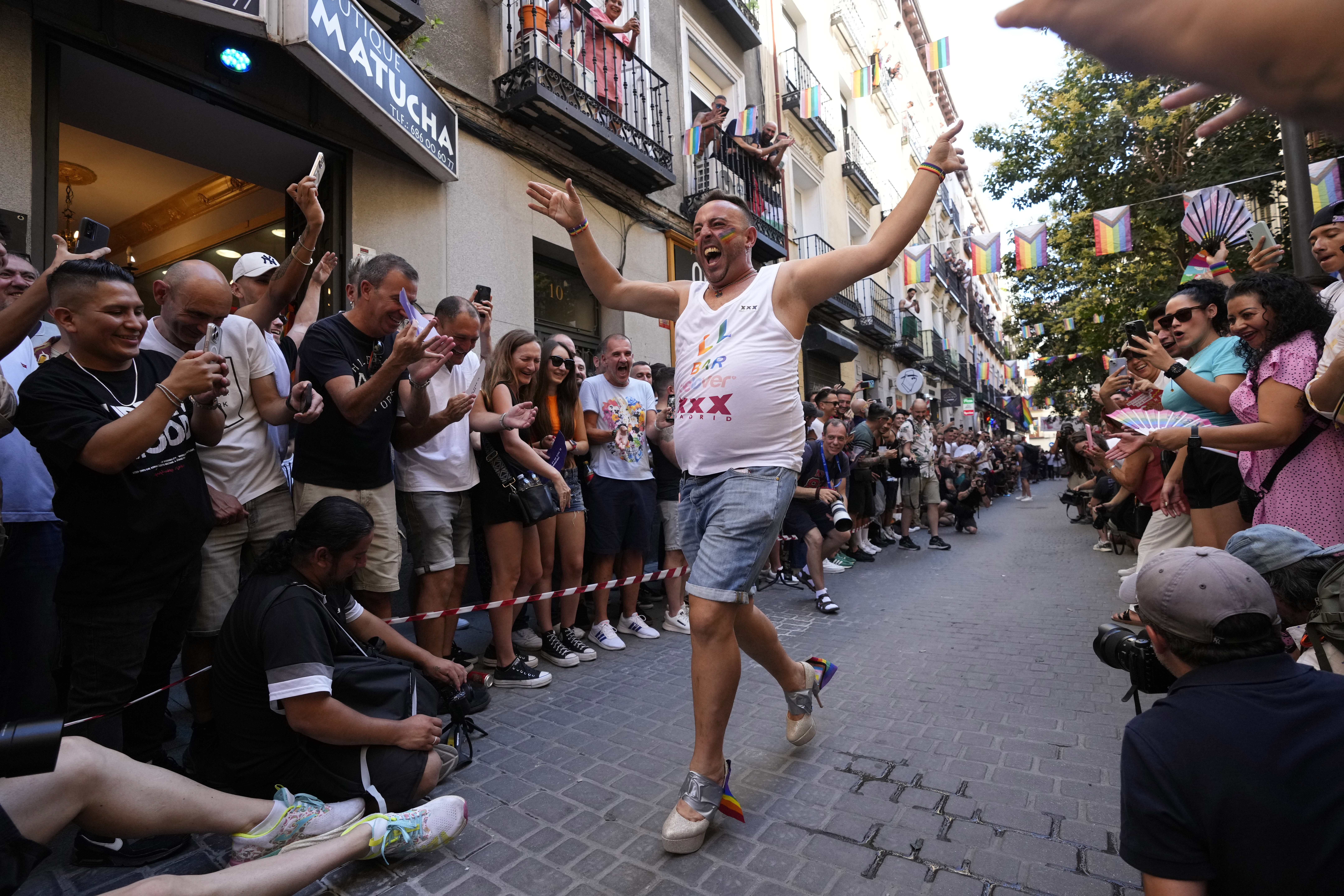 A participant reacts while coming in last during the Pride Week annual high heels race in the Chueca district, a popular area for the gay community in Madrid, Spain, Thursday, July 4, 2024. (AP Photo/Paul White)