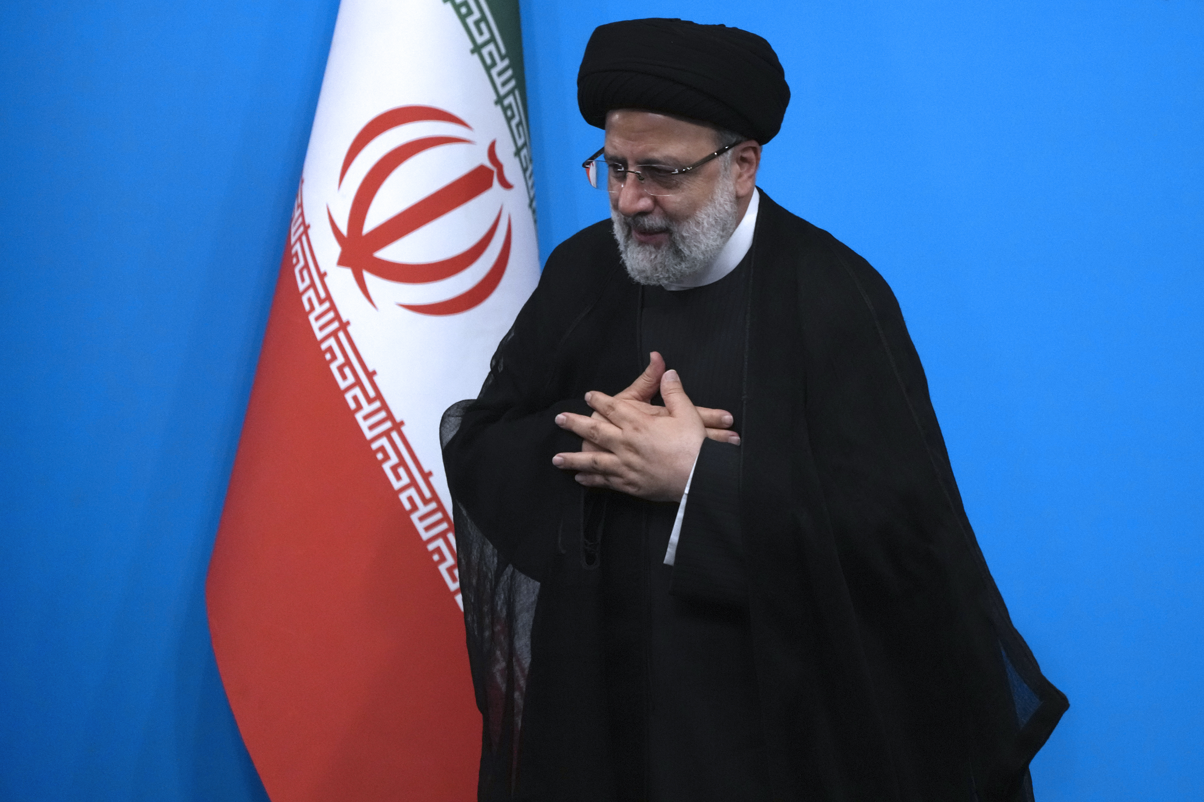 Iranian President Ebrahim Raisi places his hands on his heart as a gesture of respect as he leaves after a press conference in Tehran, Iran, Tuesday, Aug. 29, 2023. (AP Photo/Vahid Salemi)