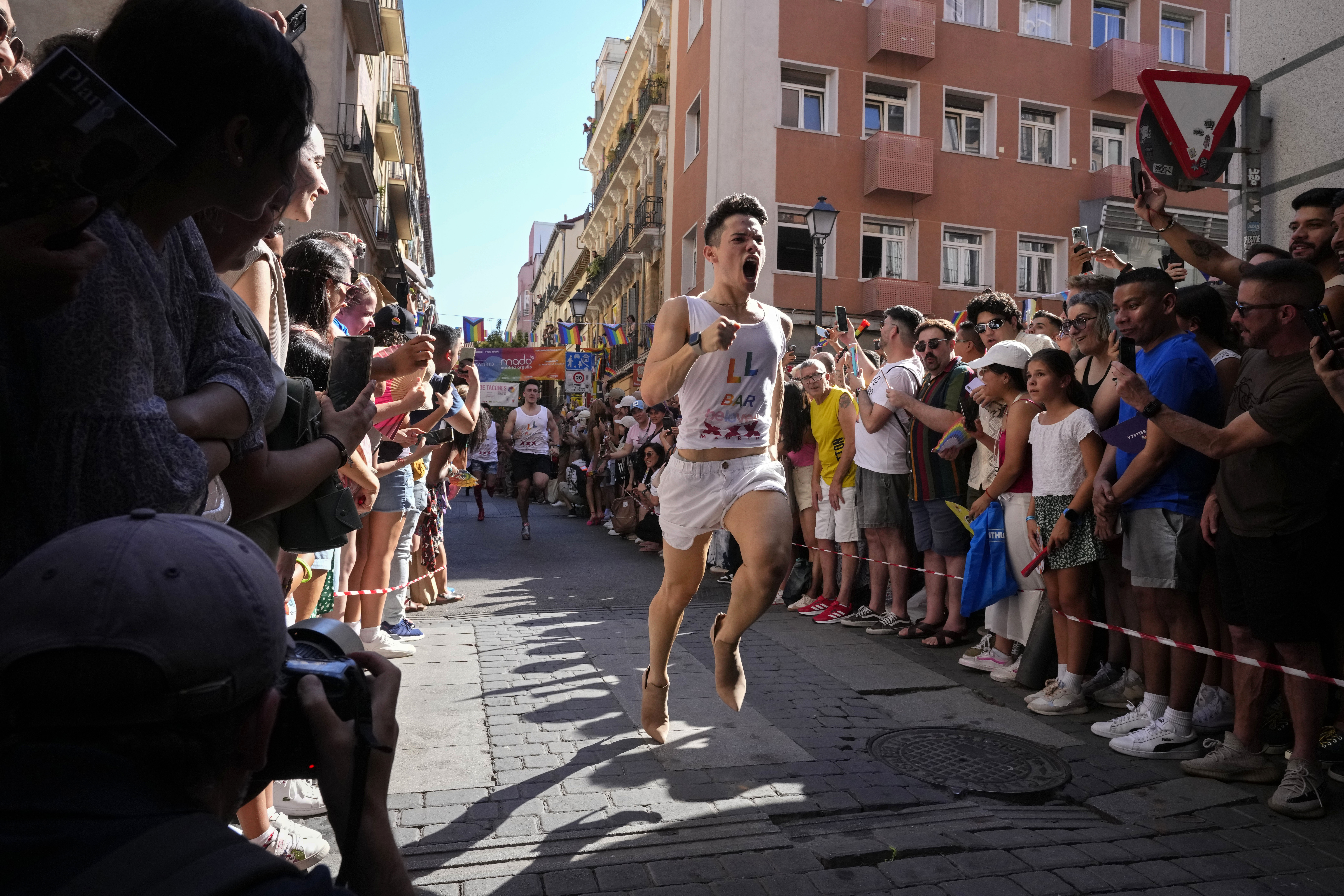 Participants compete during the Pride Week annual high heels race in the Chueca district, a popular area for the gay community in Madrid, Spain, Thursday, July 4, 2024. (AP Photo/Paul White)