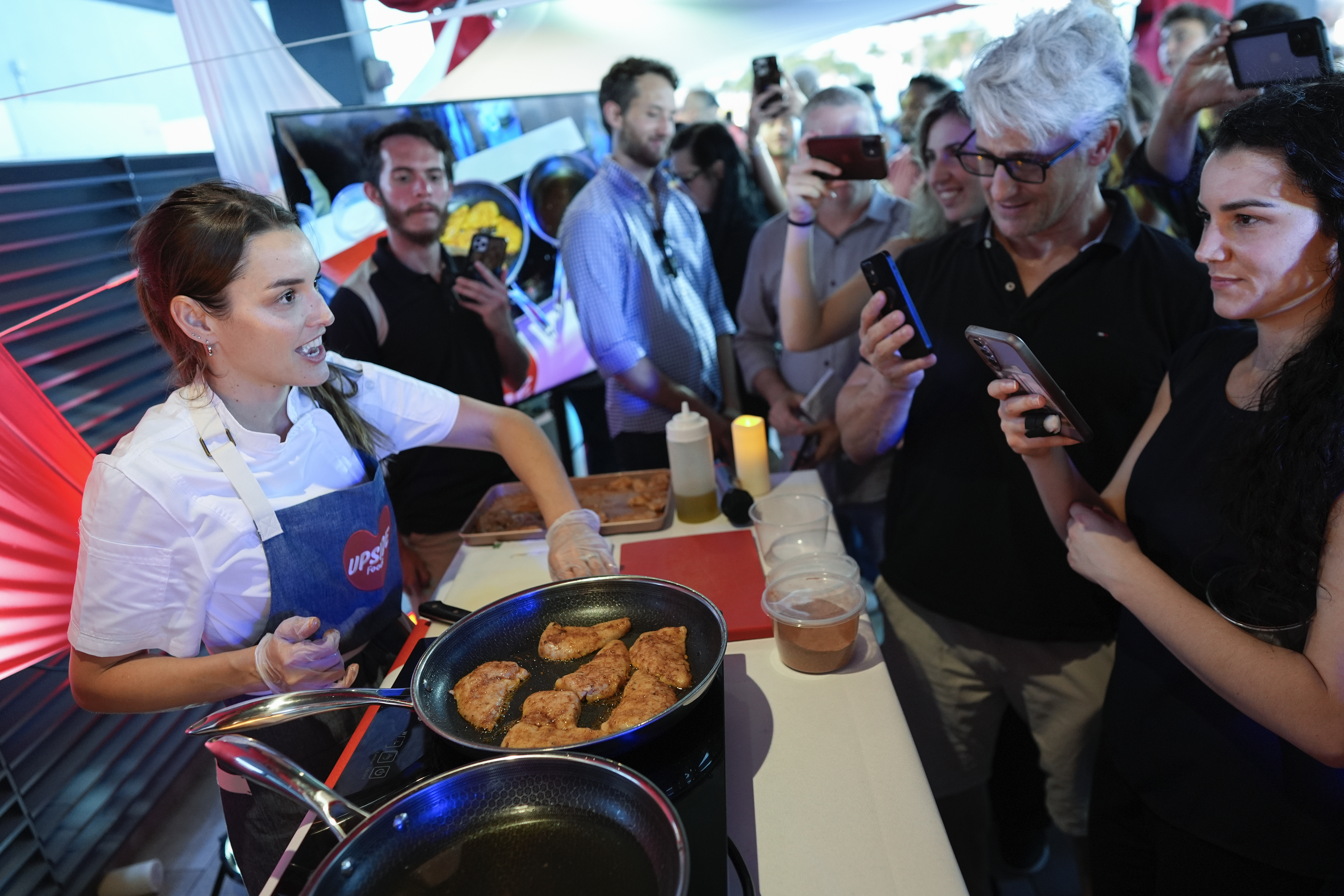 Chef Mika Leon cooks cultivated chicken at a pop-up tasting for "lab-grown" meat produced by California-based Upside Foods, Thursday, June 27, 2024, in Miami. As Florida's ban on lab-grown meat is set to go into effect next week, one manufacturer hosted a tasting party, serving up cultivated chicken tostadas to dozens of attendees on a rooftop in Miami's Wynwood neighborhood. (AP Photo/Rebecca Blackwell)