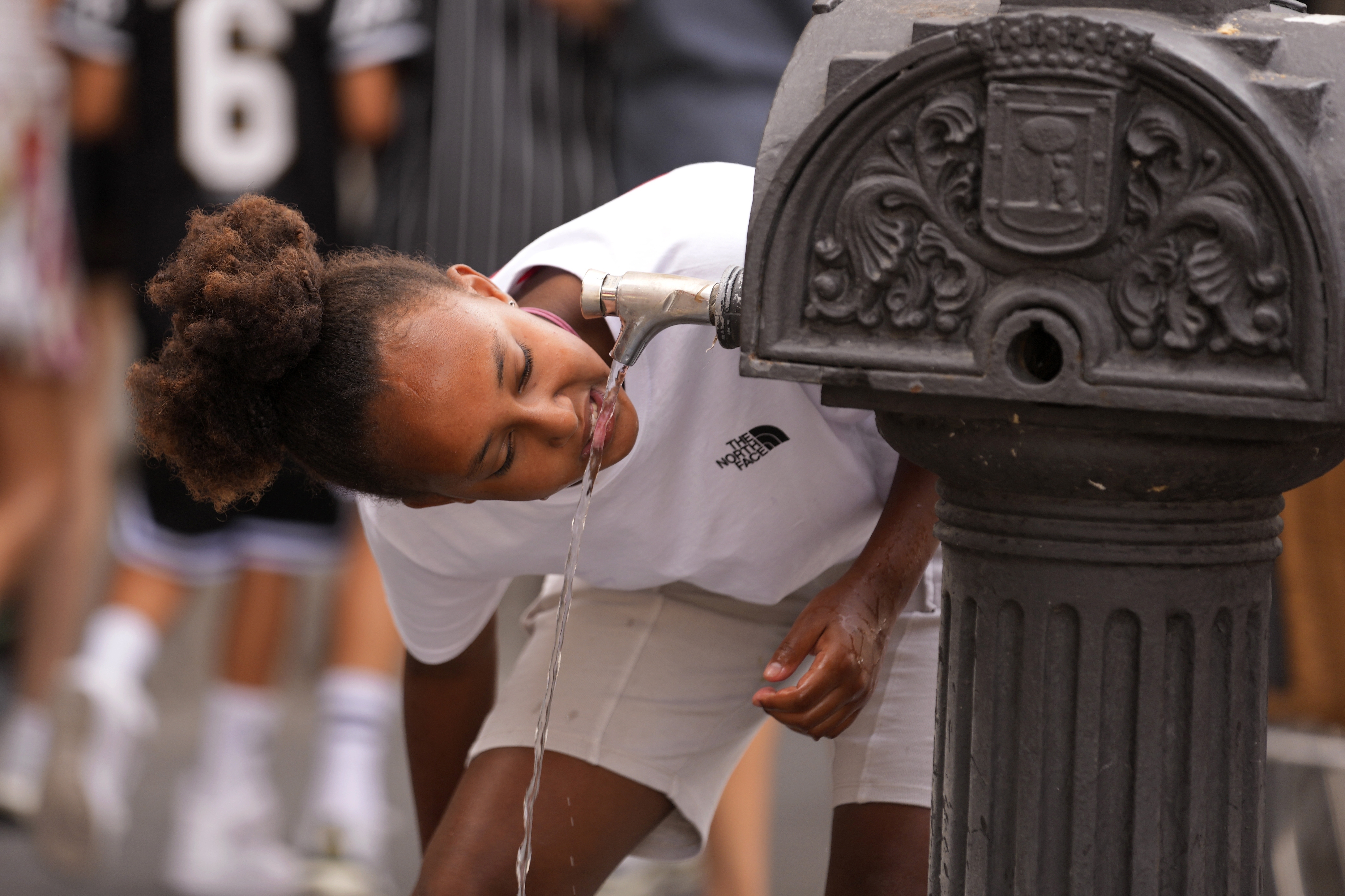 FILE - A girl drinks water from a public fountain tap in Madrid, Spain, July 18, 2023. The National Oceanic Atmospheric Administration Thursday, June 13, 2024, pronounced dead the El Nino that warms parts of the central Pacific. (AP Photo/Paul White, File)