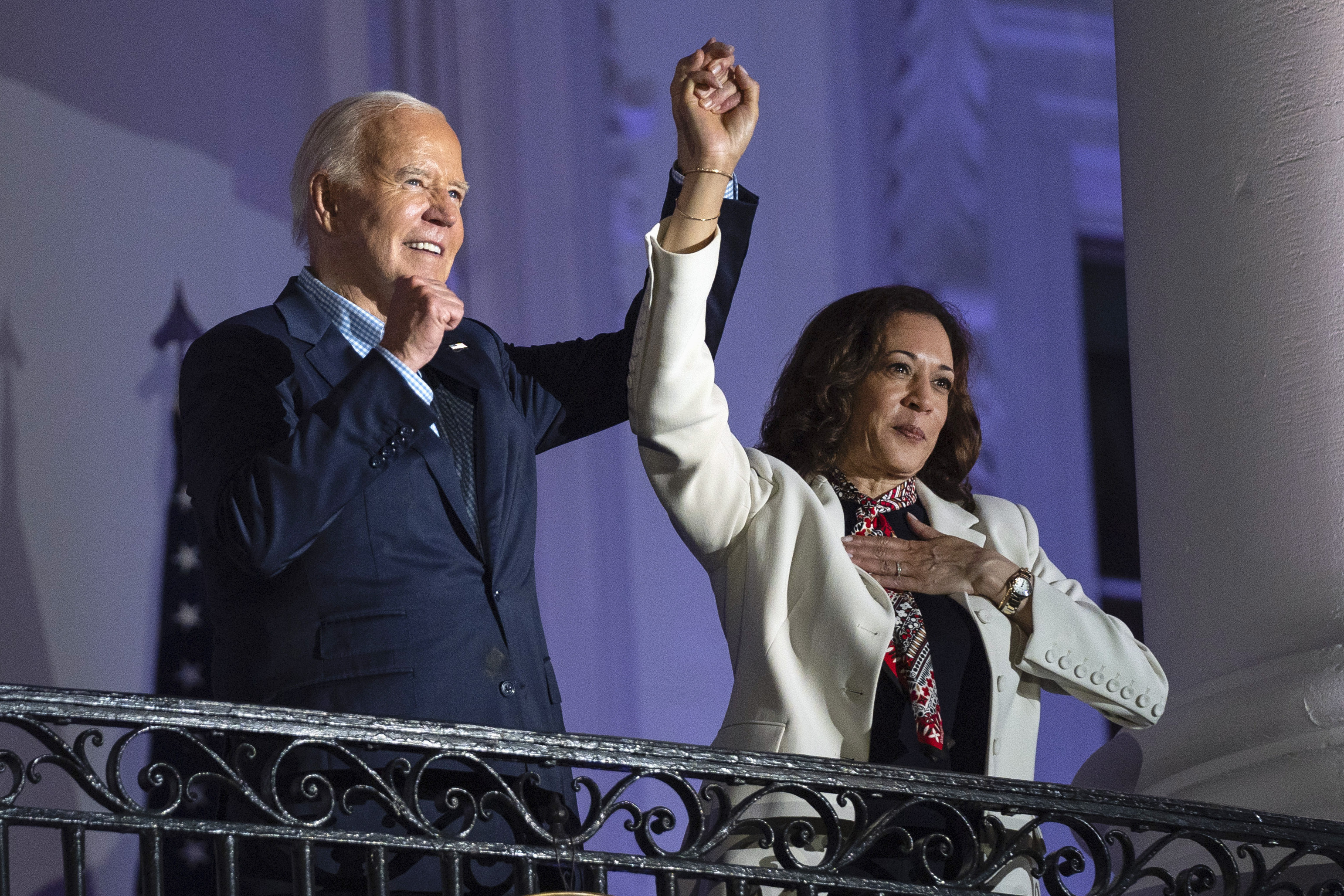 President Joe Biden raises the hand of Vice President Kamala Harris after viewing the Independence Day fireworks display over the National Mall from the balcony of the White House, Thursday, July 4, 2024, in Washington. She's already broken barriers, and now Harris could soon become the first Black woman to head a major party's presidential ticket after President Joe Biden's ended his reelection bid. The 59-year-old Harris was endorsed by Biden on Sunday, July 21, after he stepped aside amid widespread concerns about the viability of his candidacy. (AP Photo/Evan Vucci)