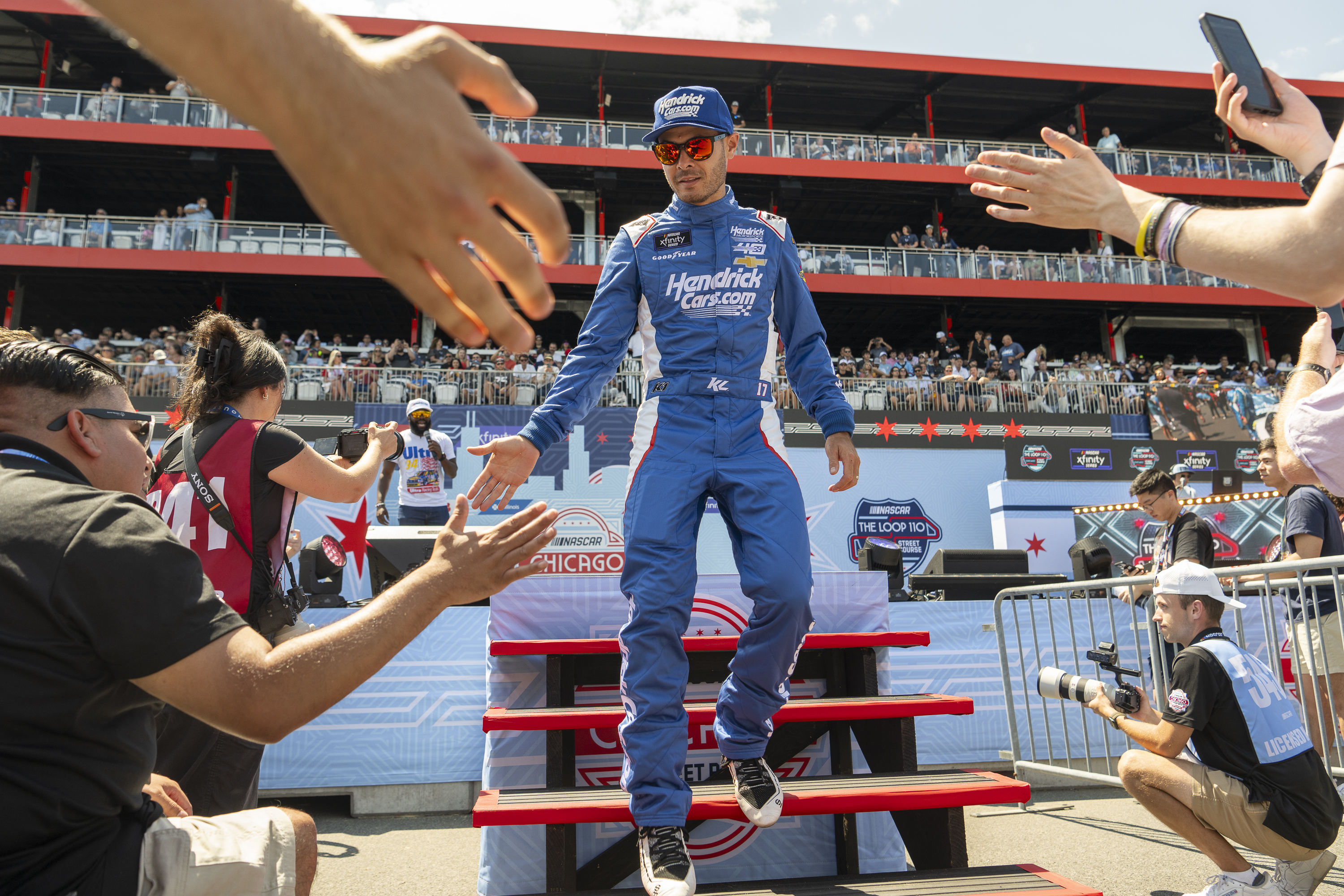 Kyle Larson (17) greets fans during the fan introduction before a NASCAR Xfinity Series street course auto race in Grant Park, Saturday, July 6, 202 4 in Chicago. (Tyler Pasciak LaRiviere/Chicago Sun-Times via AP)