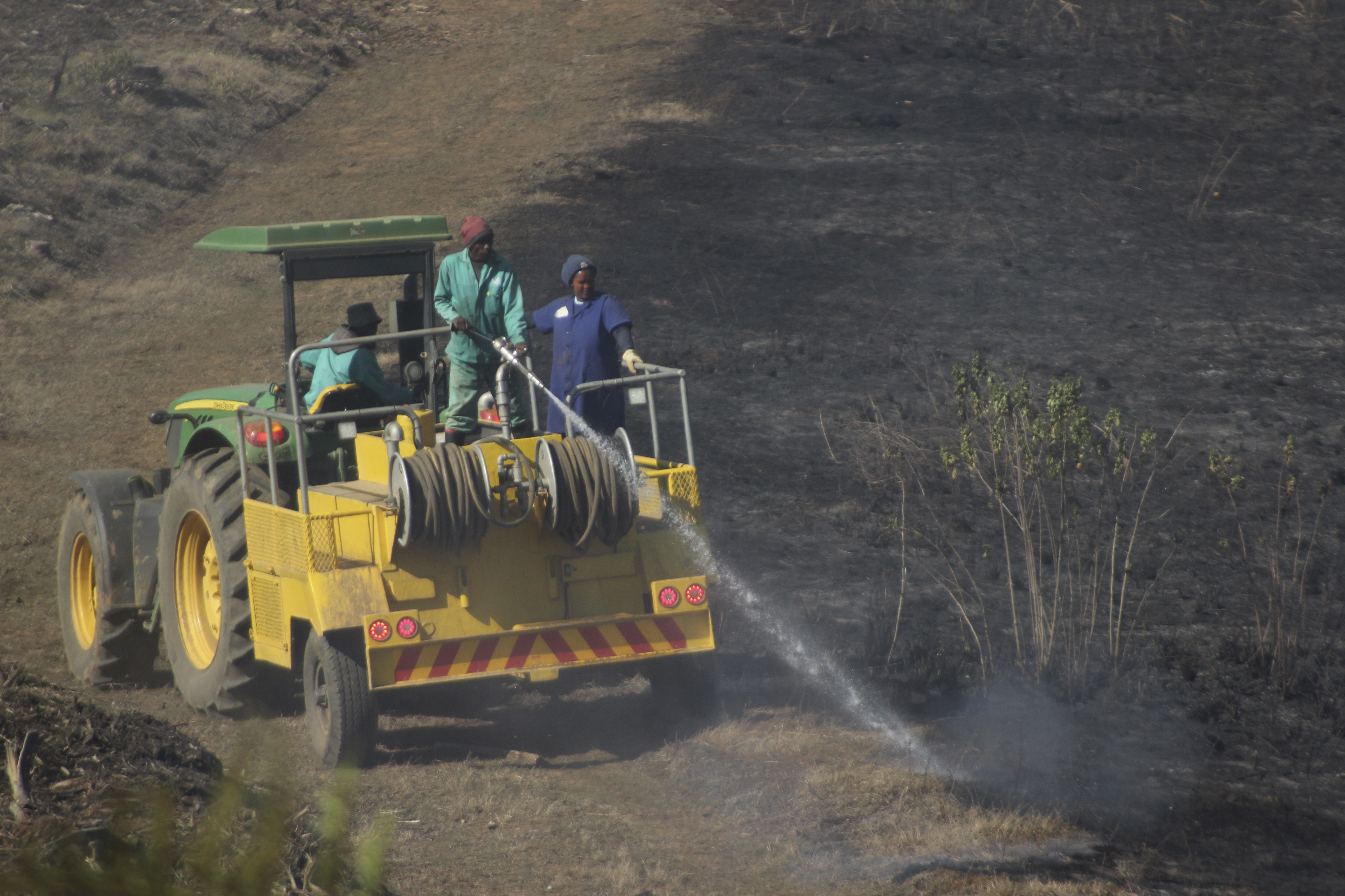 Firemen douse a wildfire in Howick, near Durban, South Africa, Wednesday, July 10, 2024. South Africa's emergency services said Monday, July 15, 2024, that several firefighters have died battling a bushfire in the eastern KwaZulu-Natal province and another few are in a critical condition. Authorities said they suspect that Sunday's fire may have been started by poachers trying to trap animals to kill. (AP Photo)