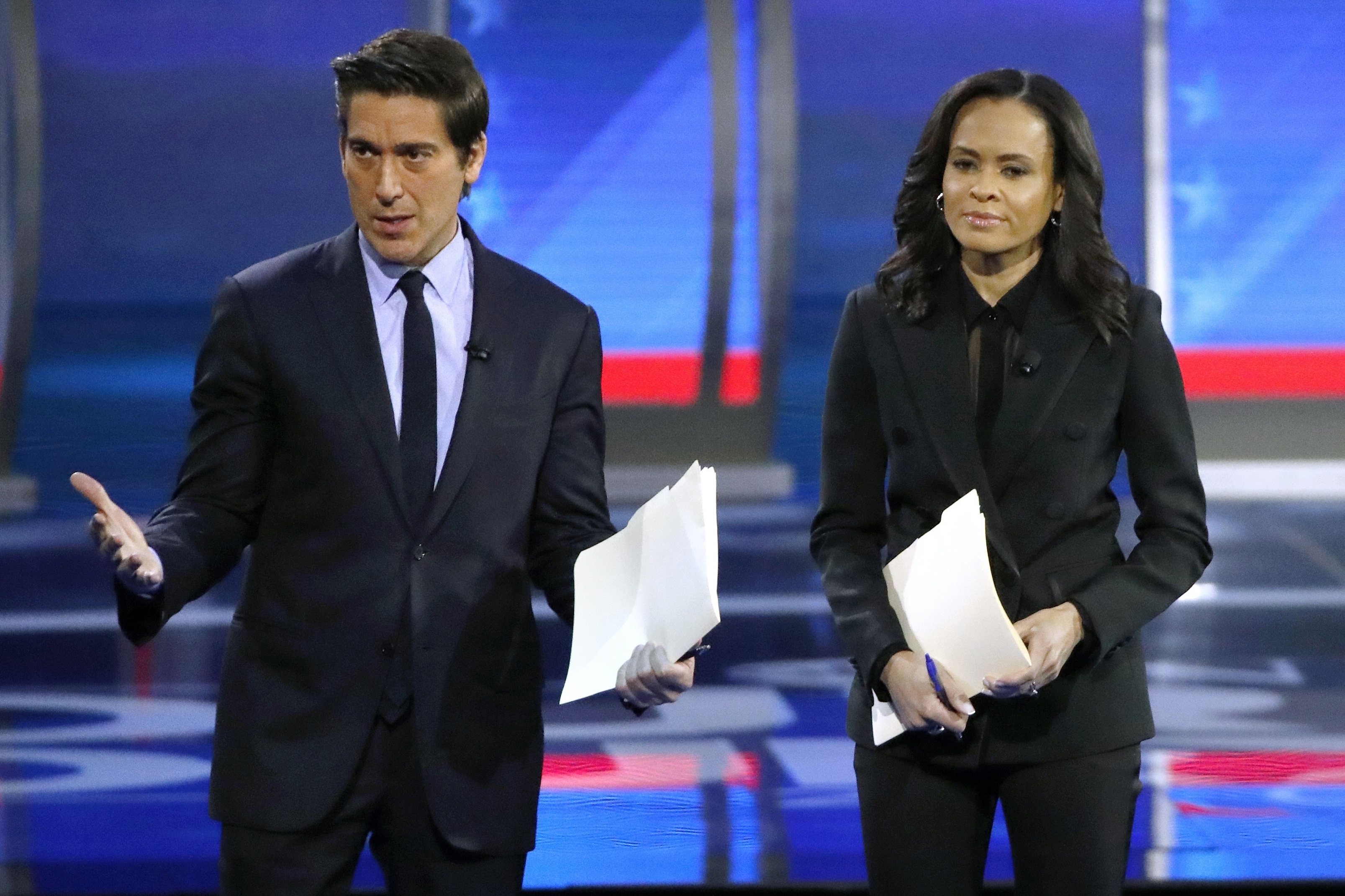 FILE - ABC World News Tonight Anchor David Muir, left, addresses members of the audience while standing with ABC News Live Anchor Linsey Davis, Friday, Feb. 7, 2020 in Manchester, N.H. (AP Photo/Elise Amendola, File)