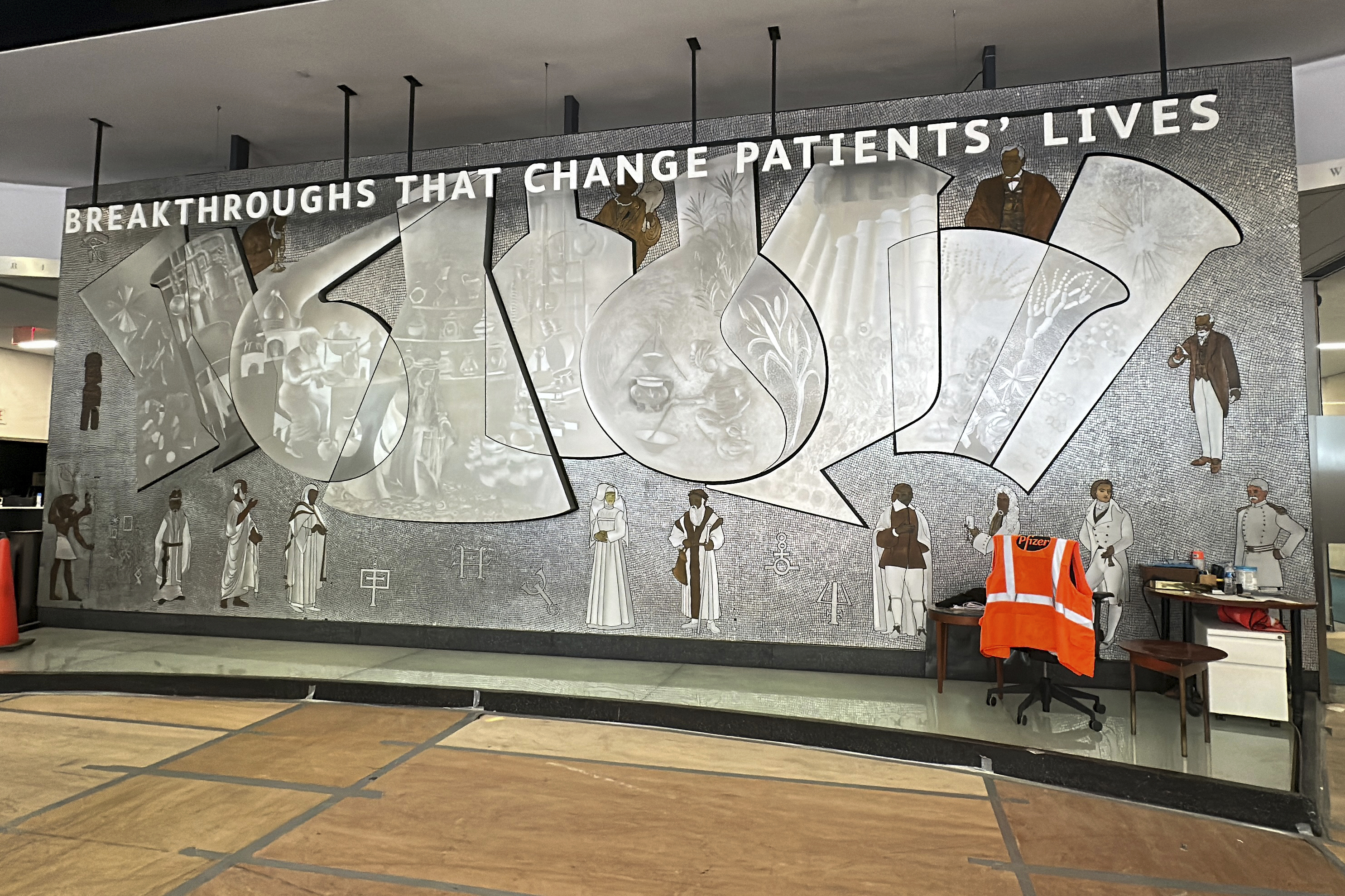 A metal mosaic mural created in 1960 by Greek-born artist Nikos Bel-Jon and titled "Medical Research Through the Ages" is in the lobby of the old Pfizer headquarters in New York on Thursday, August 29, 2024. (AP Photo/Ted Shaffrey)