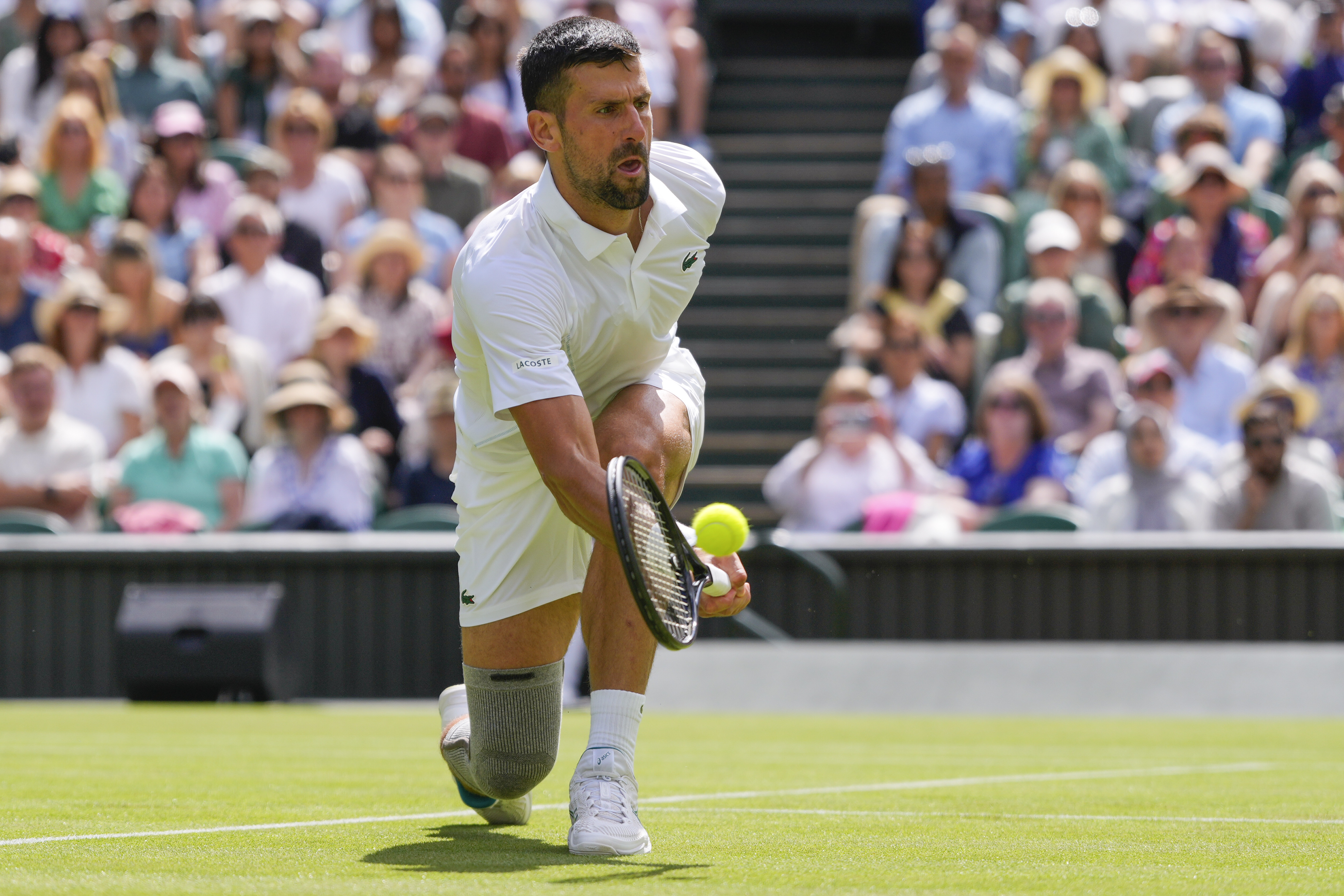 Serbia's Novak Djokovic plays a forehand return to Britain's Jacob Fearnley during their second round match at the Wimbledon tennis championships in London, Thursday, July 4, 2024. (AP Photo/Kirsty Wigglesworth)