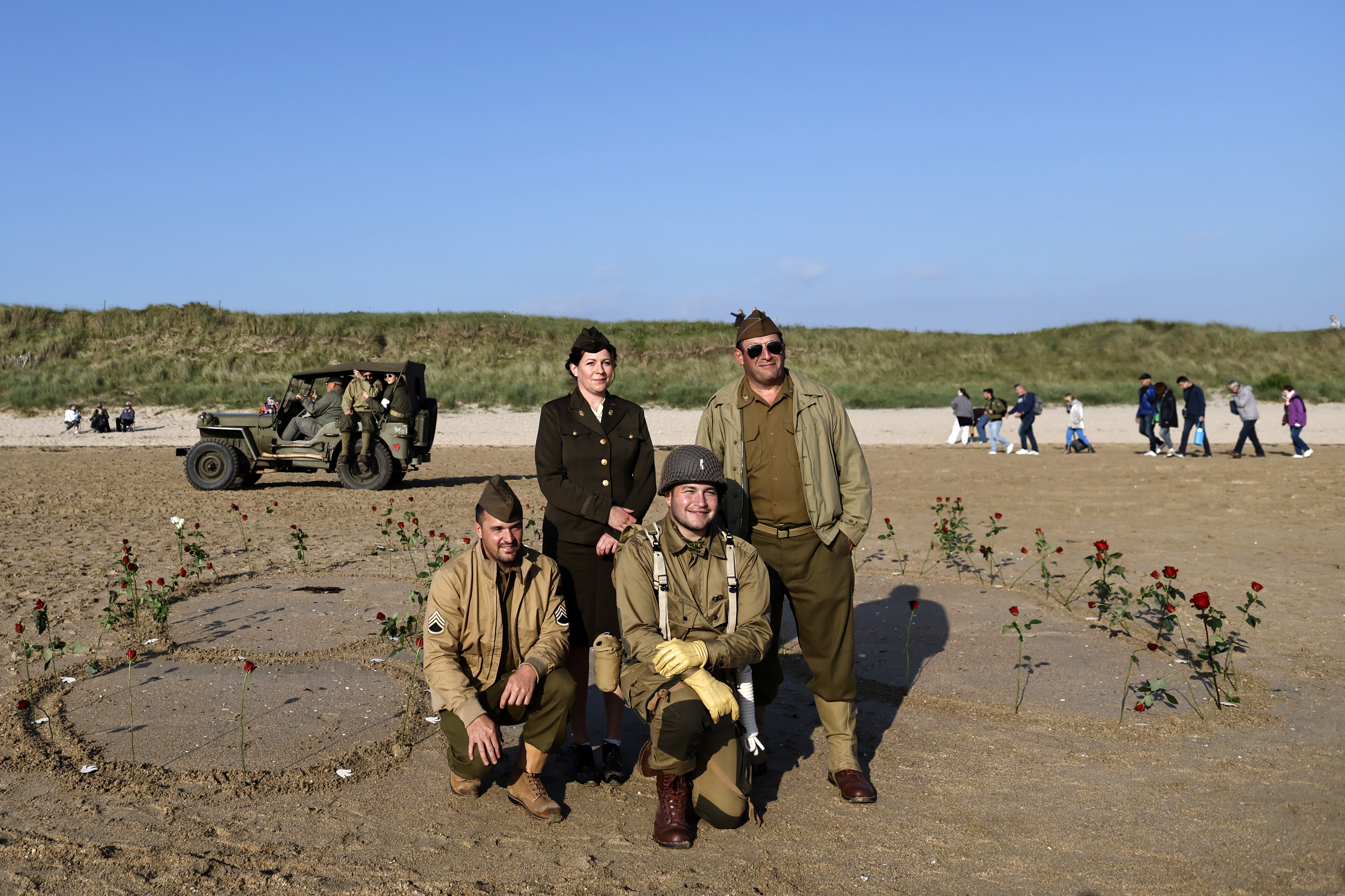 Re enactors pose for a photo during a ceremony at Utah Beach near Saint-Martin-de-Vareville Normandy, Thursday, June 6, 2024. World War II veterans from across the United States as well as Britain and Canada are in Normandy this week to mark 80 years since the D-Day landings that helped lead to Hitler's defeat. (AP Photo/Jeremias Gonzalez)