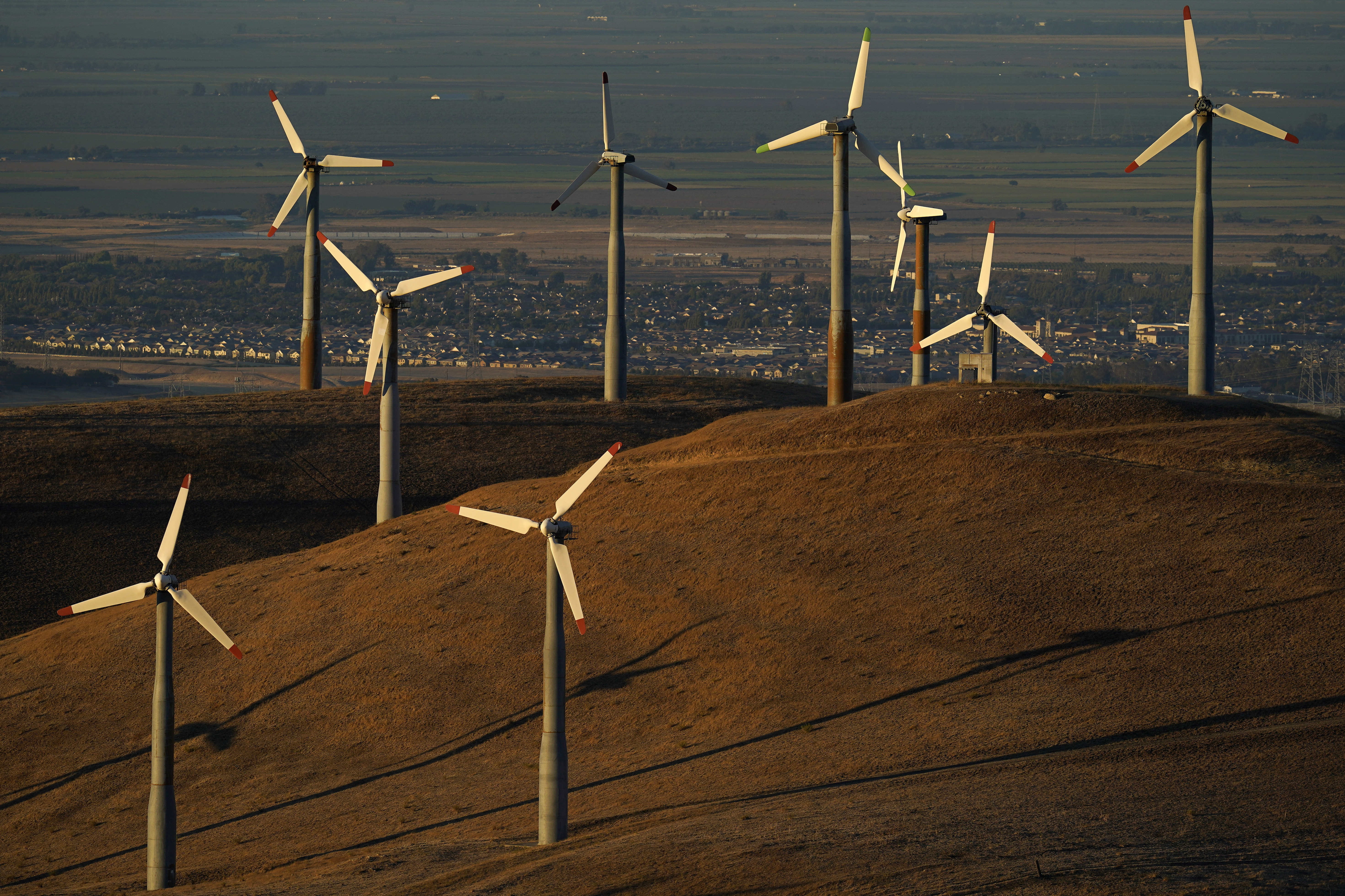 FILE - Wind turbines work in Livermore, Calif., Aug. 10, 2022. Federal energy regulators on Monday, May 13, 2024, approved a long-awaited rule to expand the amount of renewable energy such as wind and solar power that is transmitted to the electric grid, a key part of President Joe Biden’s goal to decarbonize the economy by 2050. (AP Photo/Godofredo A. Vásquez, File)