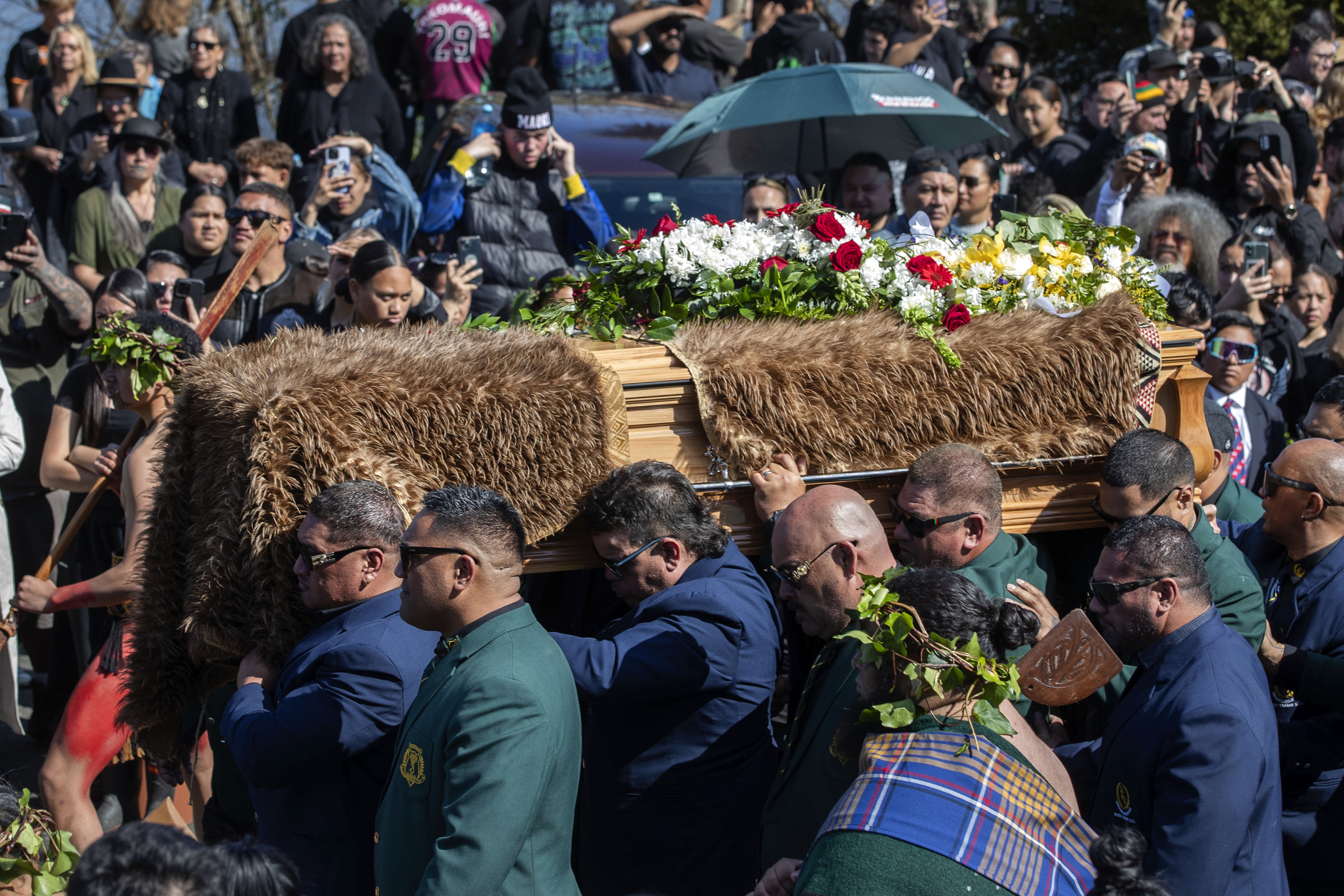 The coffin with the body of New Zealand's Maori King, Kiingi Tuheitia Pootatau Te Wherowhero VII, is carried up Taupiri Mountain for burial in Ngaruawahia, New Zealand, Thursday, Sept. 5, 2024. (AP Photo/Alan Gibson)