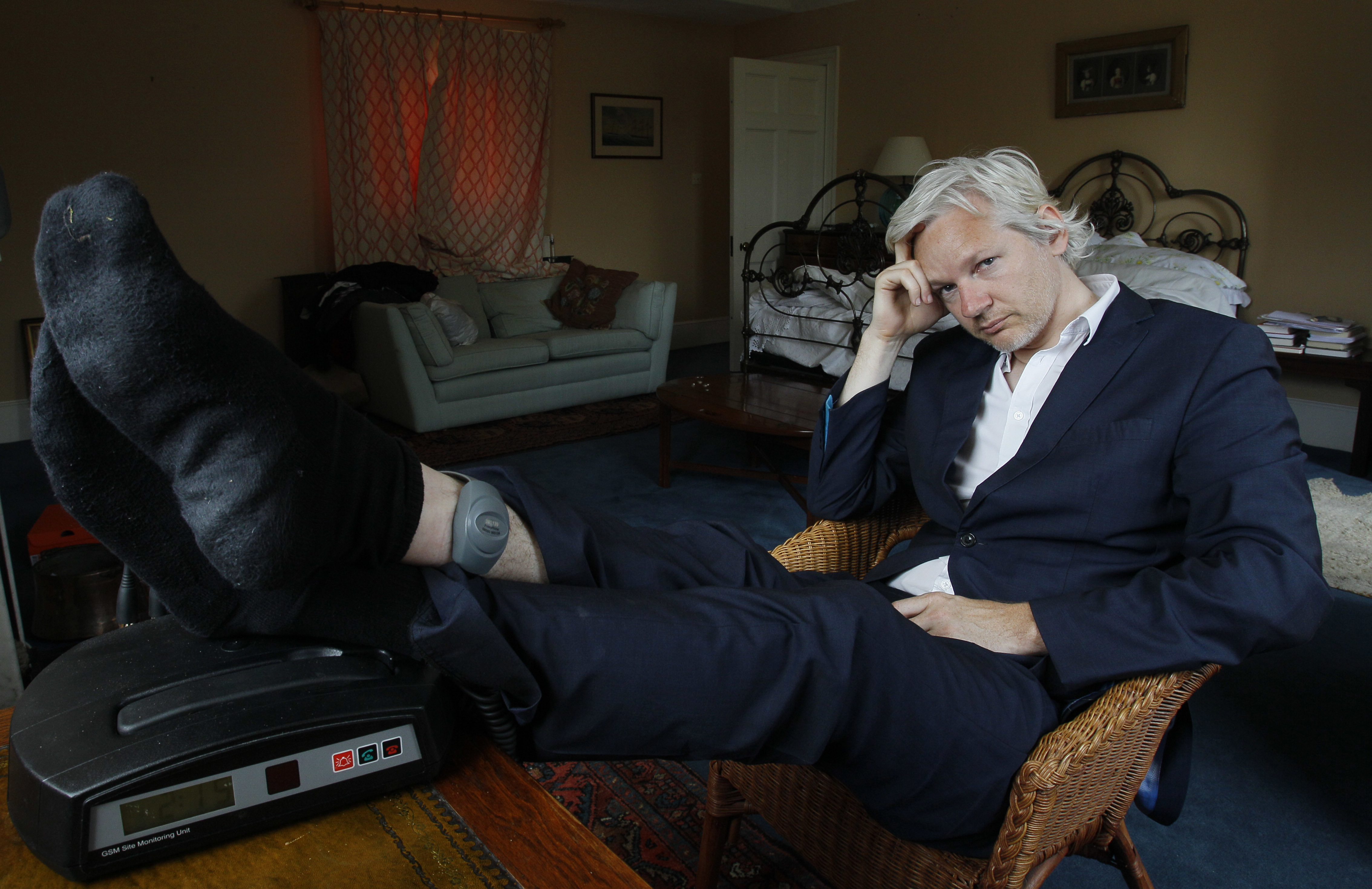 FILE - WikiLeaks founder Julian Assange is seen with his ankle security tag at the house where he is required to stay, near Bungay, England, Wednesday, June 15, 2011. Assange will plead guilty to a felony charge in a deal with the U.S. Justice Department that will free him from prison and resolve a long-running legal saga over the publication of a trove of classified documents. (AP Photo/Kirsty Wigglesworth, File)