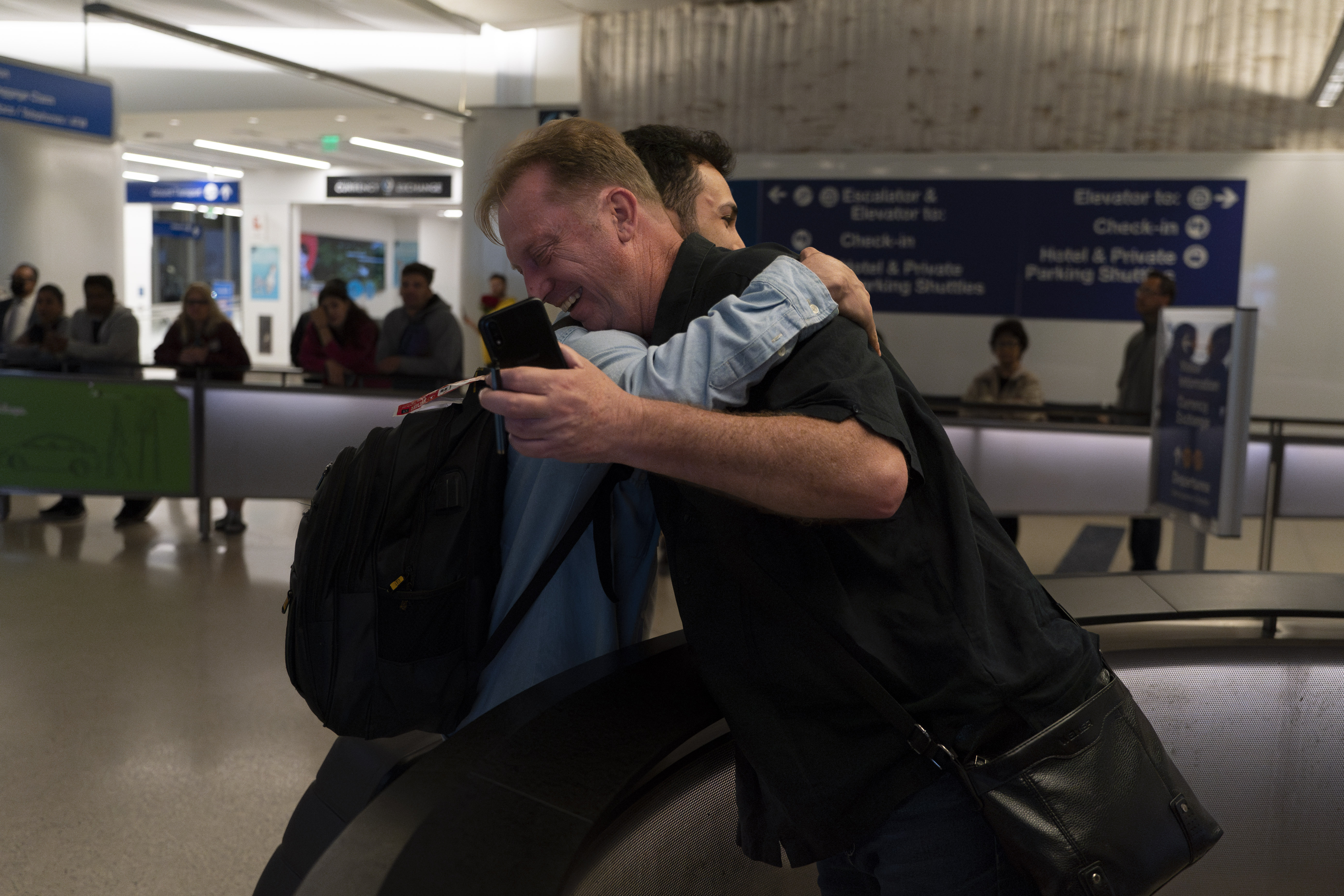 Michael White, a Navy veteran who was jailed in Iran for several years on spying charges, right, hugs Michael's former fellow prisoner and Iranian political activist Mahdi Vatankhah at the Los Angeles International Airport in Los Angeles, Thursday, June 1, 2023. Vatankhah, while in custody and after his release, helped White by providing White's mother with crucial, firsthand accounts about her son's status in prison and by passing along letters White had written while he was locked up. Once freed, White did not forget. He pushed successfully this year for Vatankhah's admission to the United States, allowing the men to be reunited last spring, something neither could have envisioned when they first met in prison years earlier. (AP Photo/Jae C. Hong)