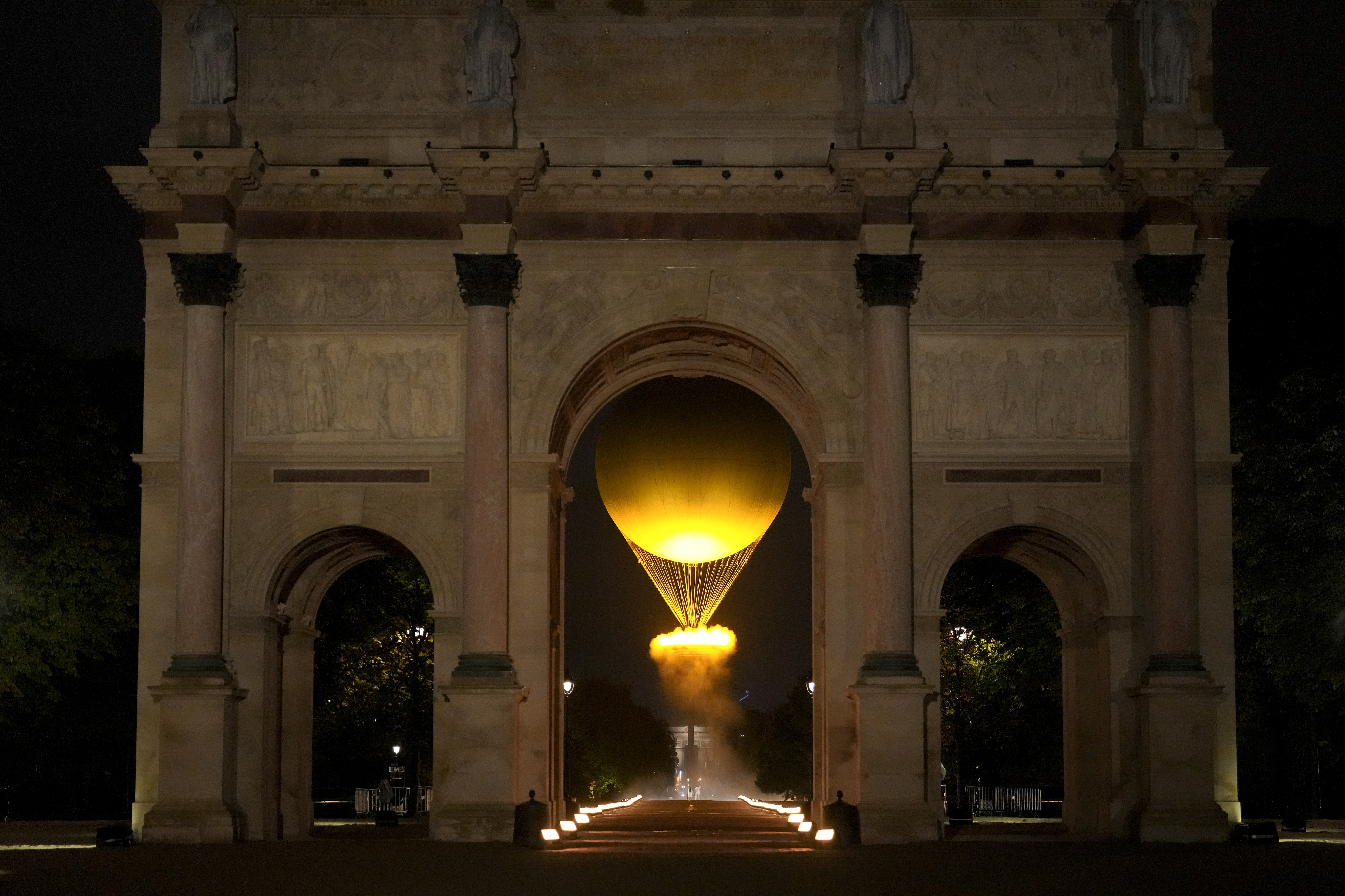 The cauldron rises by the Arc de Triomphe du Carrousel in Paris, France, during the opening ceremony of the 2024 Summer Olympics, Friday, July 26, 2024. (AP Photo/Vadim Ghirda)