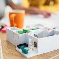 Close-up of architectural model in desk while female architects working on background