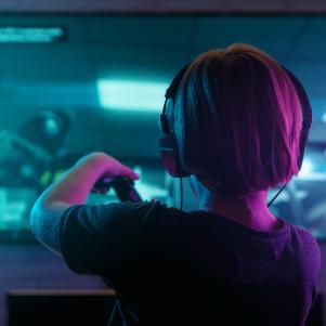 Little boy playing video game in the dark room